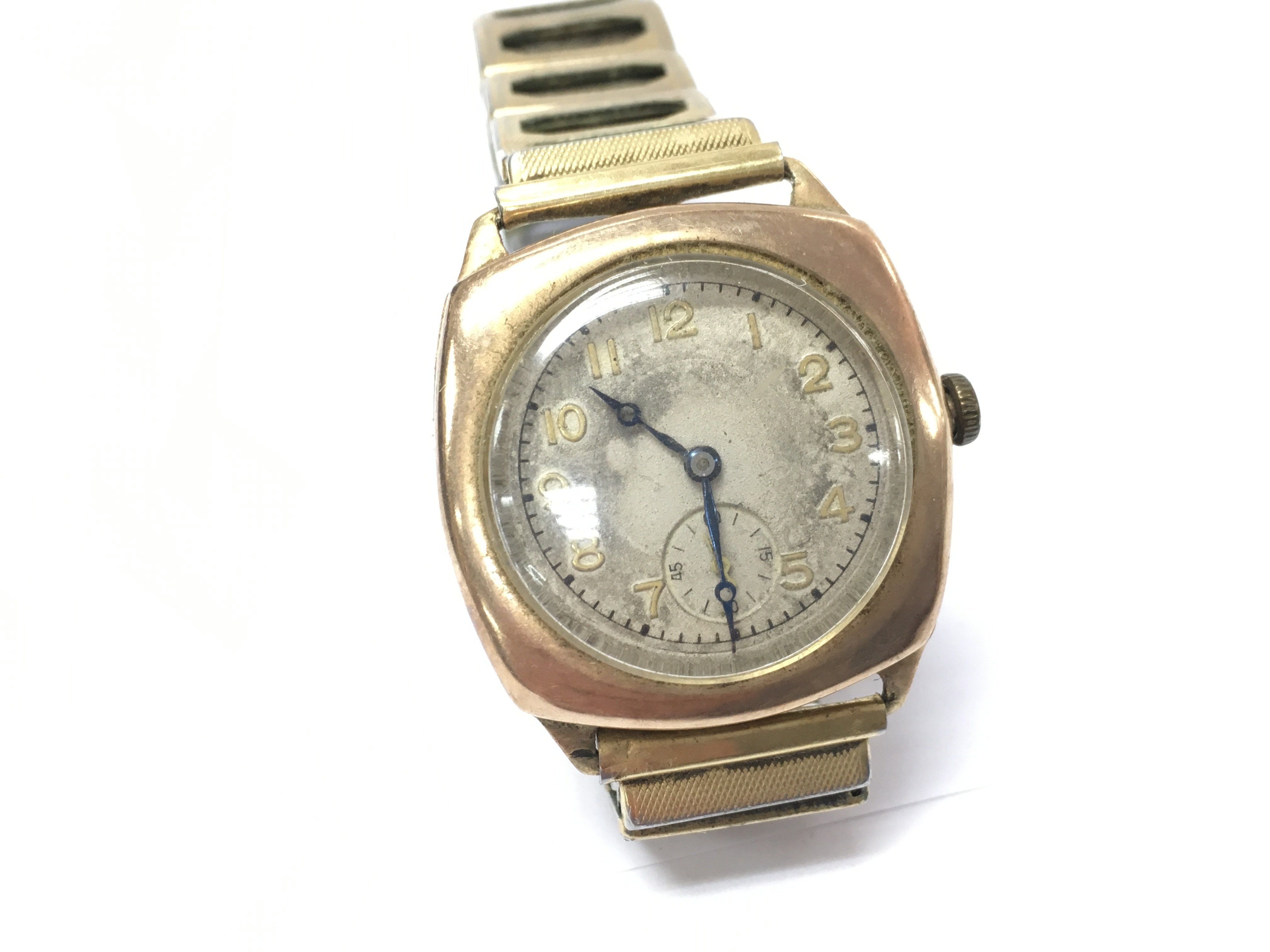 A 9ct gold watch on an expandable strap. seen running.