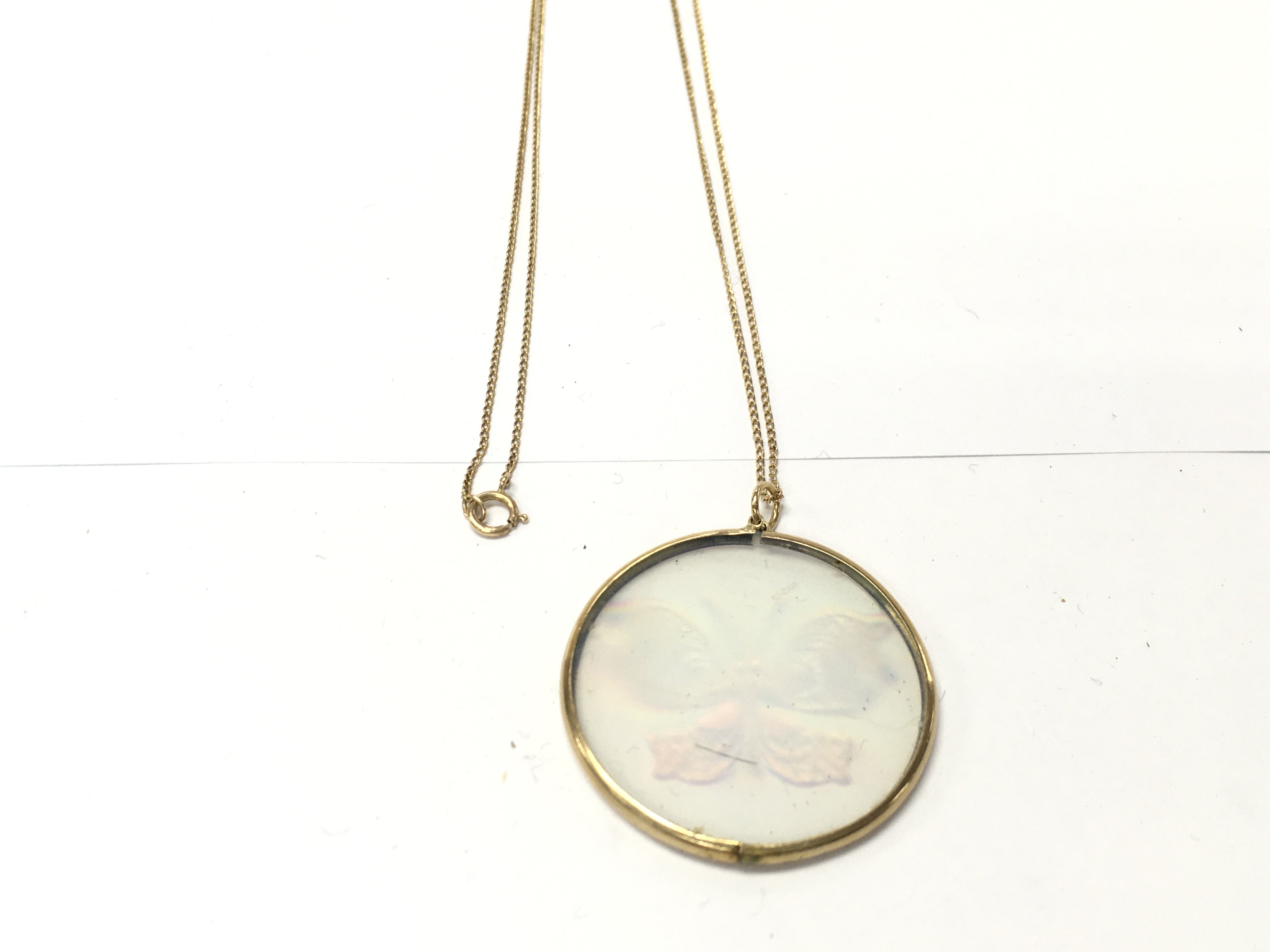 A 9ct gold chain with a butterfly hologram pendant. 8.6g total