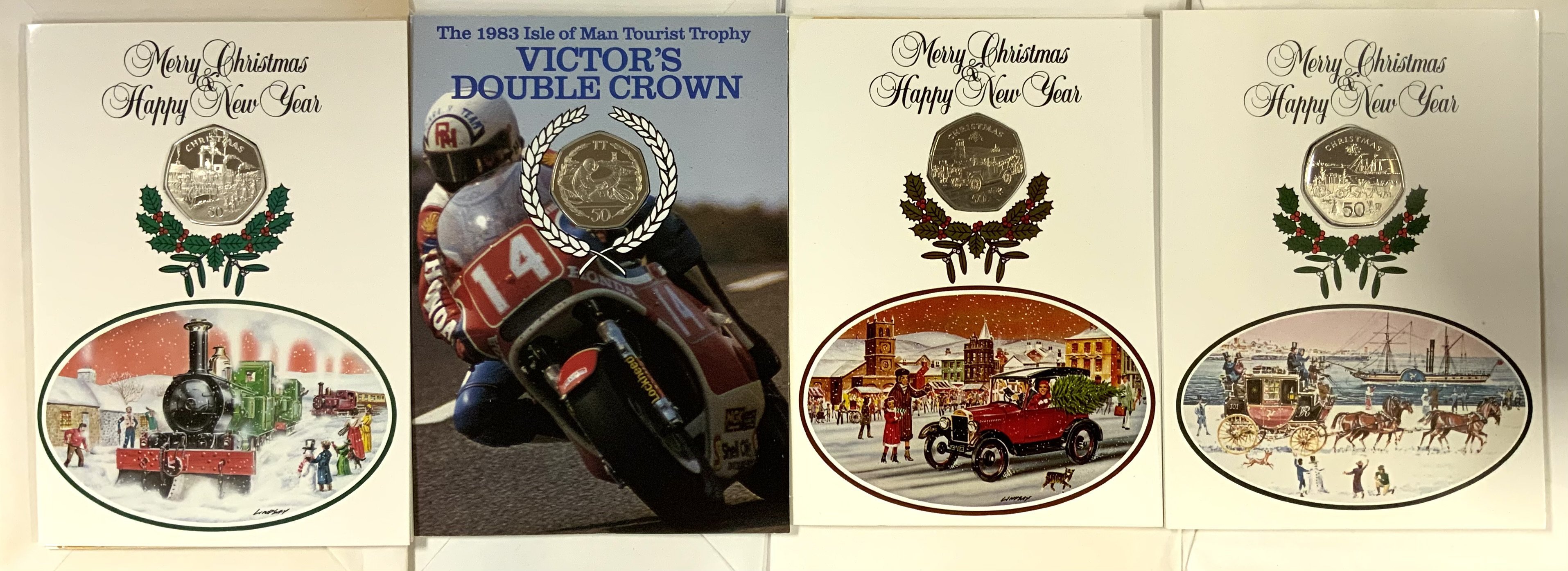 3 Pobjoy Mint Isle of Man Christmas cards inset with 50p coins, 1980, 1983, 1984 together with a 1983 Victory TT double crown 50p