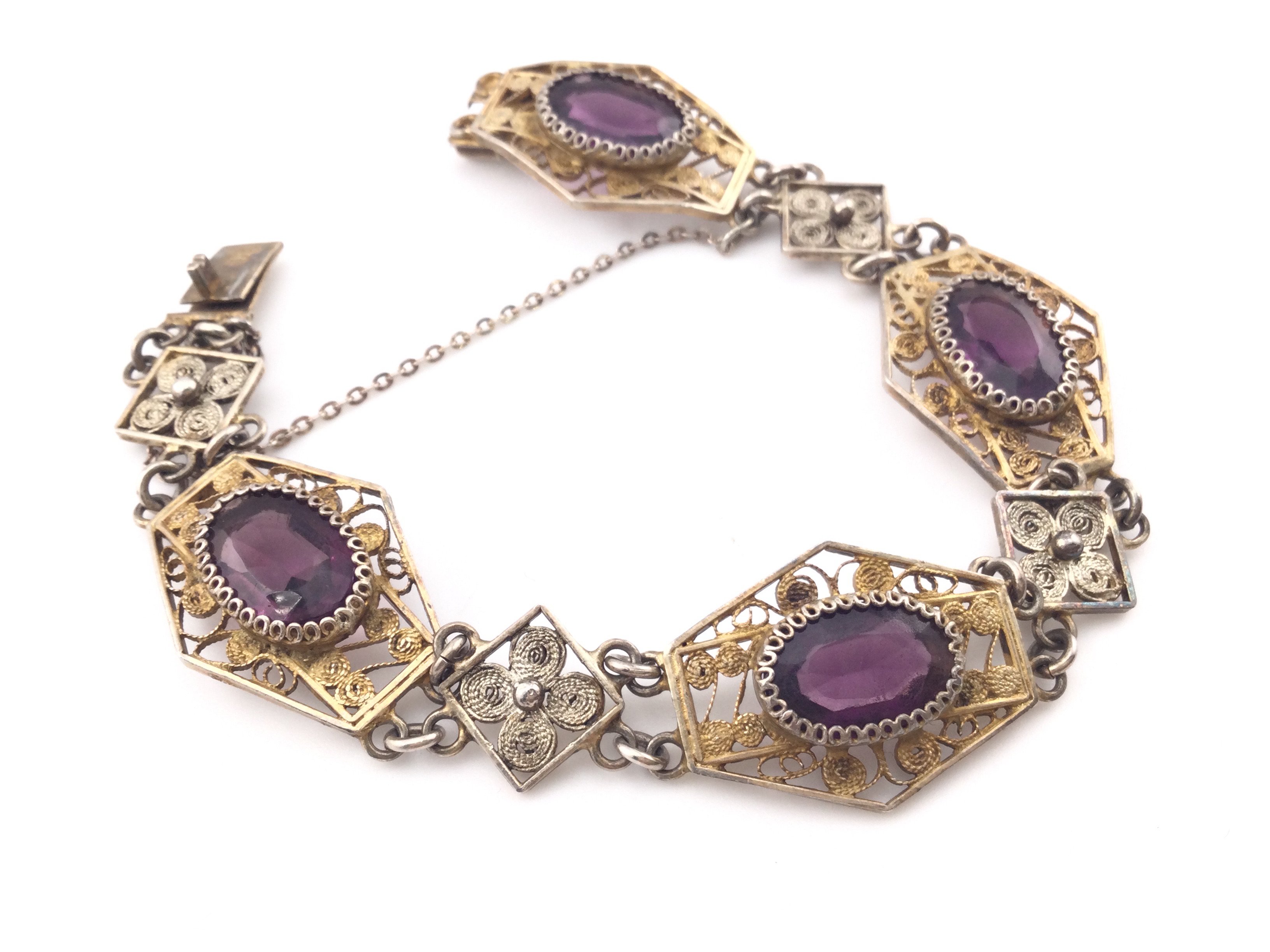 An Edwardian style silver bracelet set with purple stones. Postage A. NO RESERVE