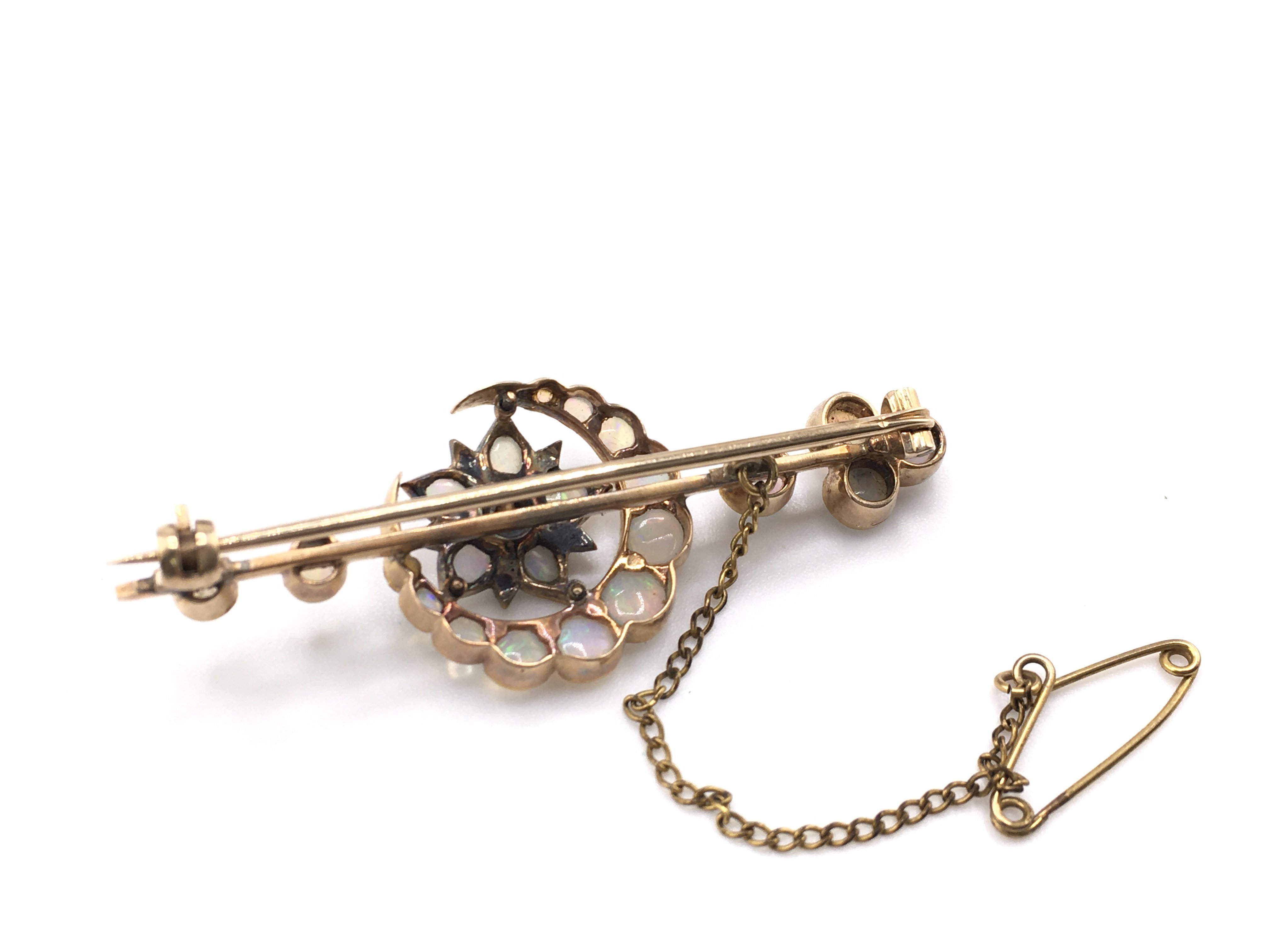 An Edwardian opal and diamond crescent moon and flower brooch. High carat gold.Postage A