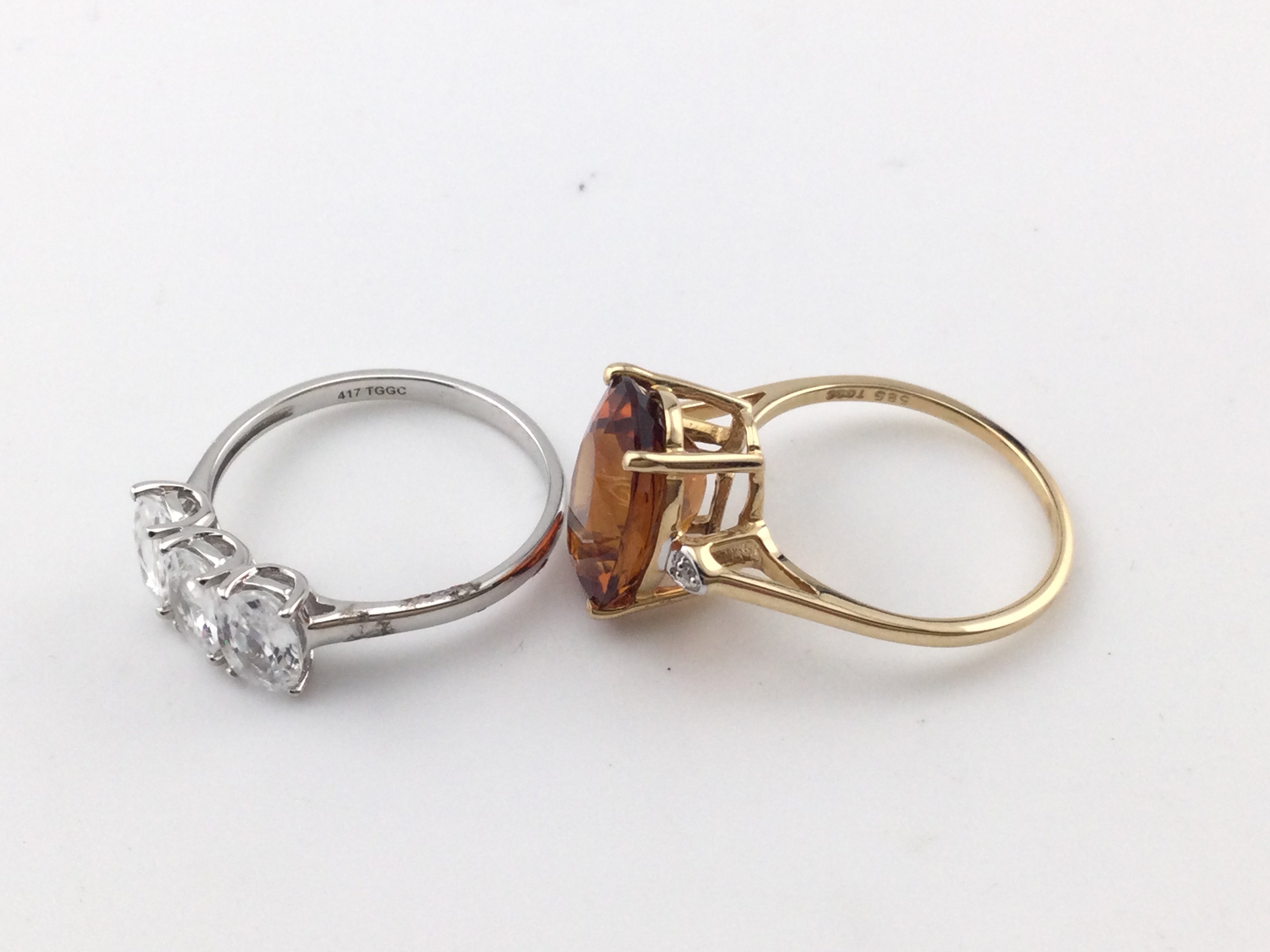 A 10k white gold three stone ring 2.8g and size R and a 14k gold cocktail ring size P and 3.40g Postage B