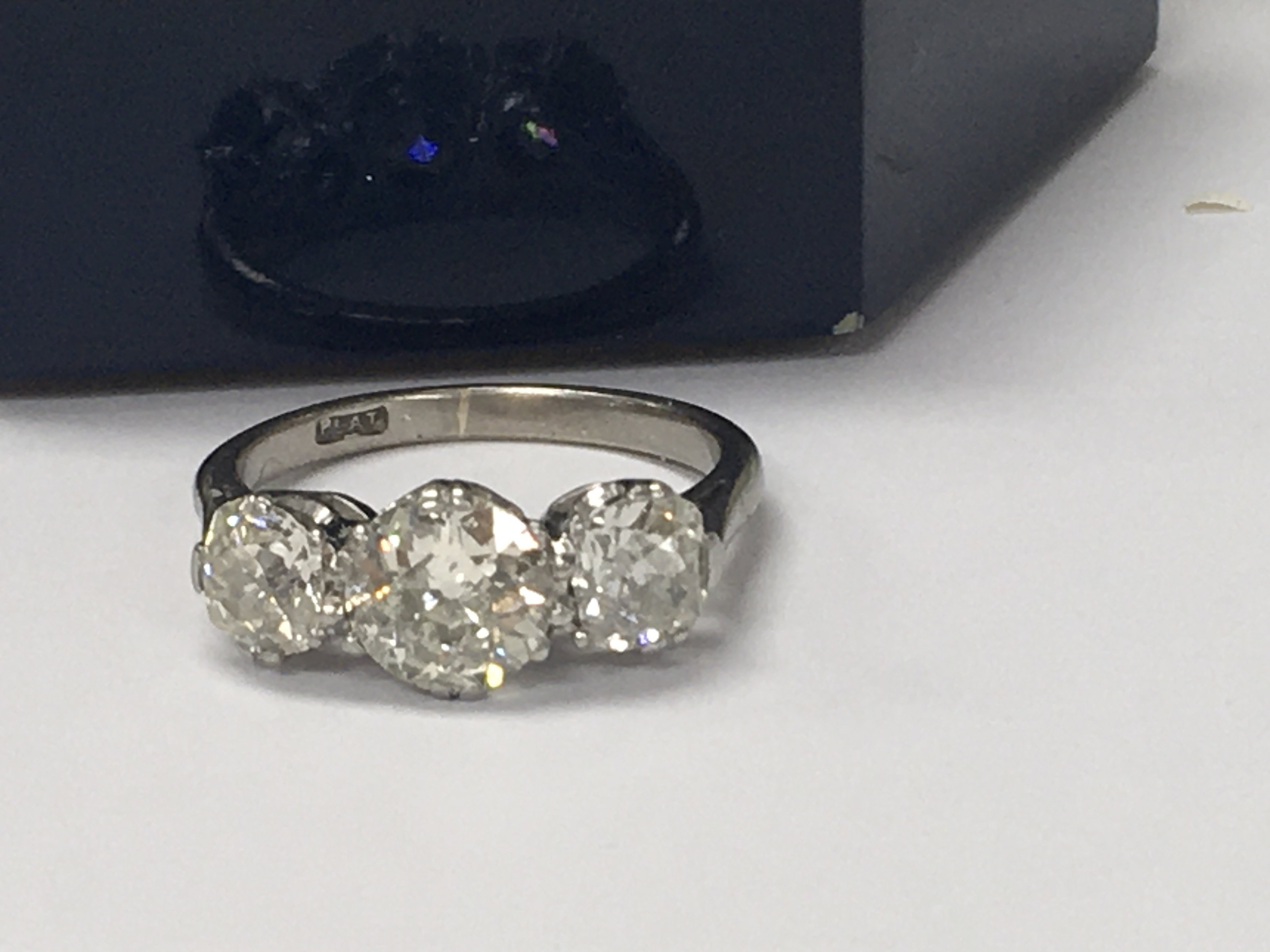 A platinum ring inset with three diamonds total weight 2ct Approx . Size L