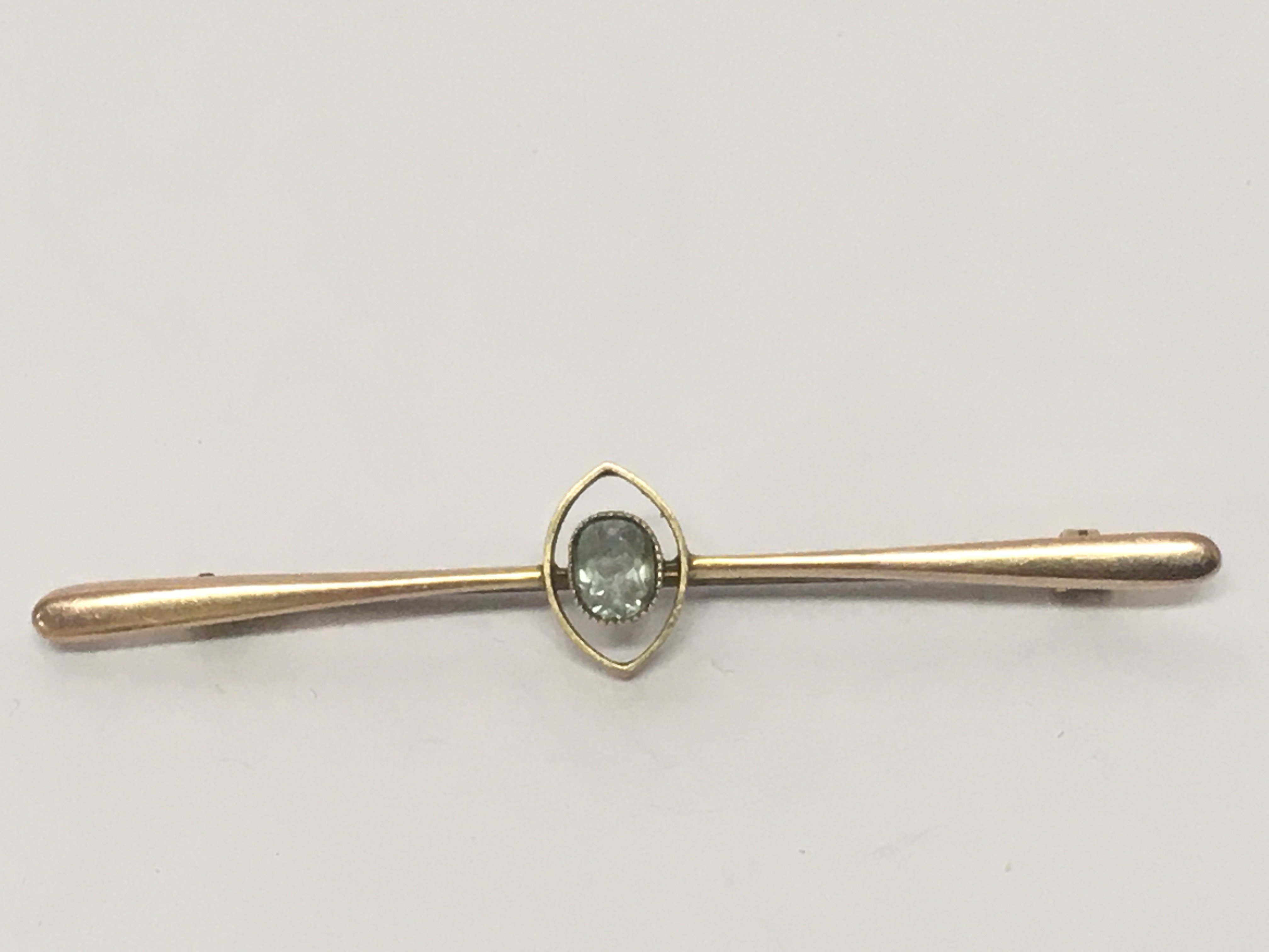 A gold cased ladies watch set on an open simulated ribbon gold plated brooch and a gold bar brooch. NO RESERVE