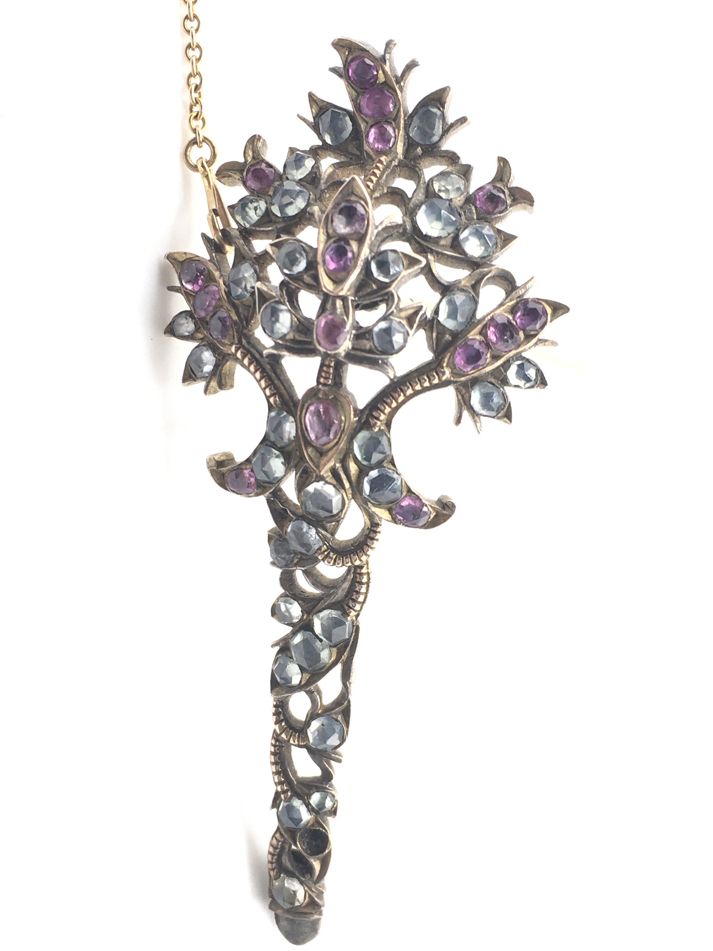 A fine Edwardian brooch (conversion) inset with a spray of Pink rubies and Aquamarine rose cut stones, possibly originally a section from a tiara. (Missing one stone), inconclusive results for metal (gold/silver). 7.5cm x 3.5cm. Total weight 15.60g.