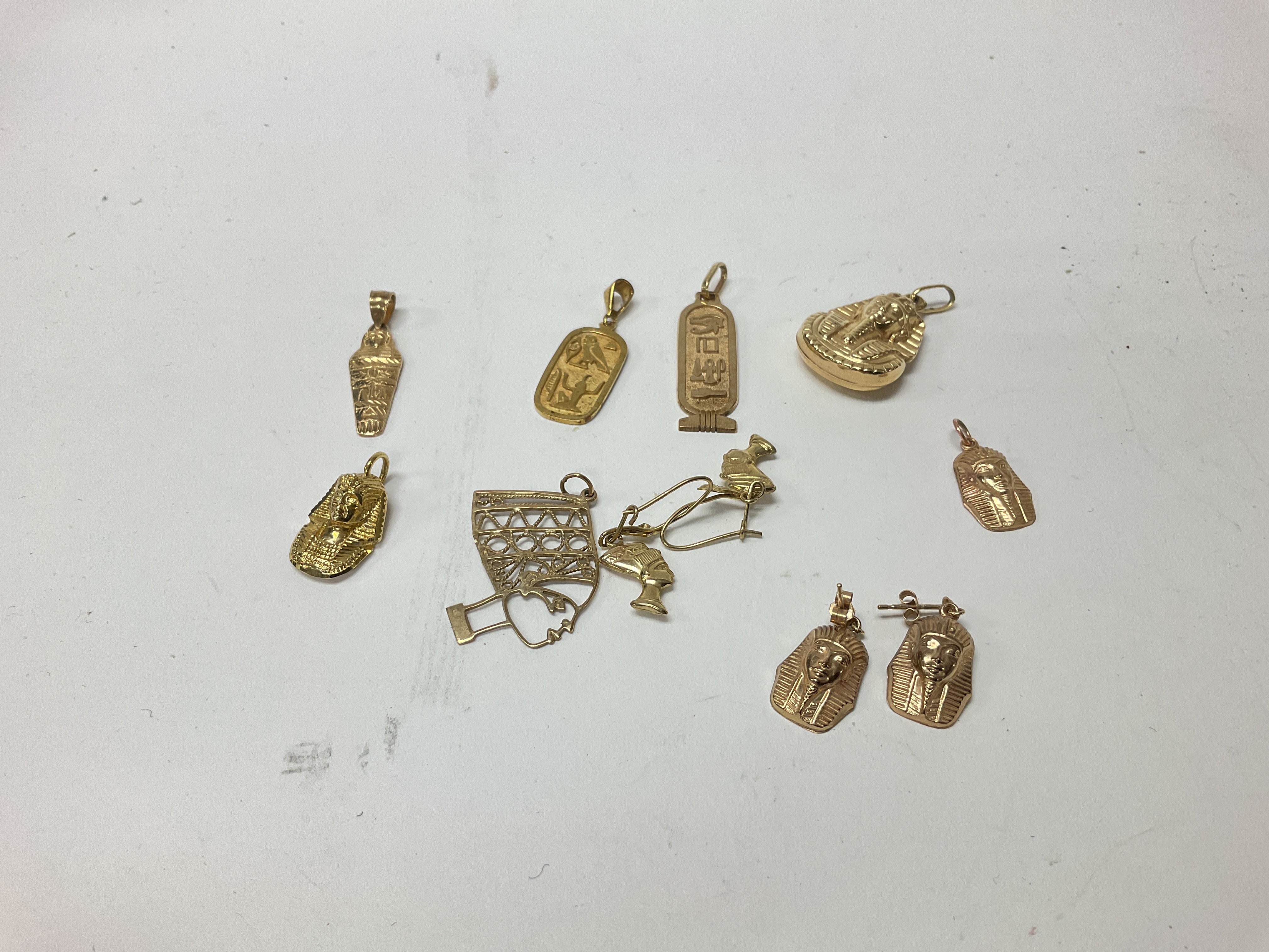 A collection of 9ct gold Egyptian pendants and earrings. Approx weight 11.25 grams.