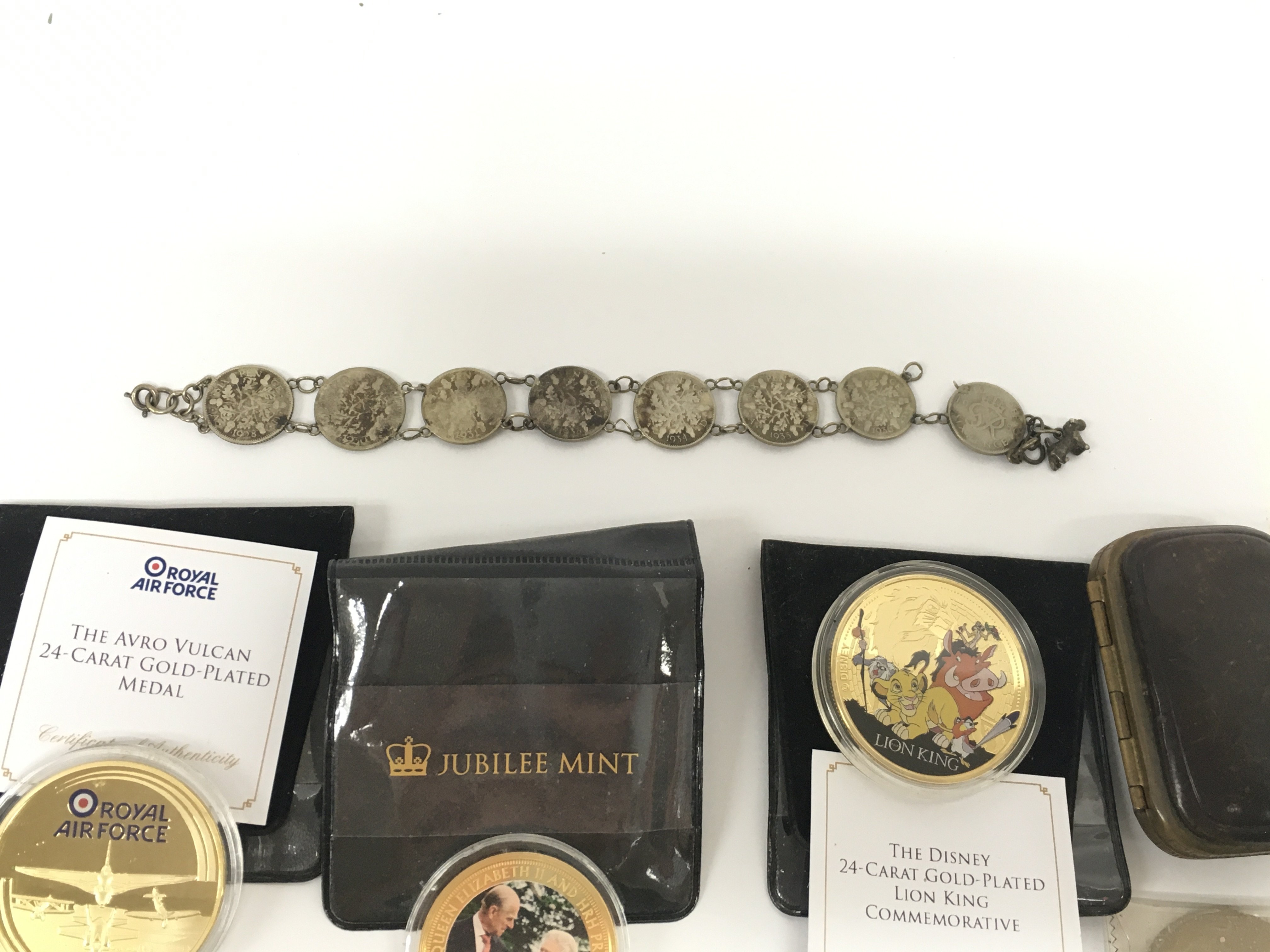 Small collection of commemorative coinage and a coin bracelet. Postage A. NO RESERVE