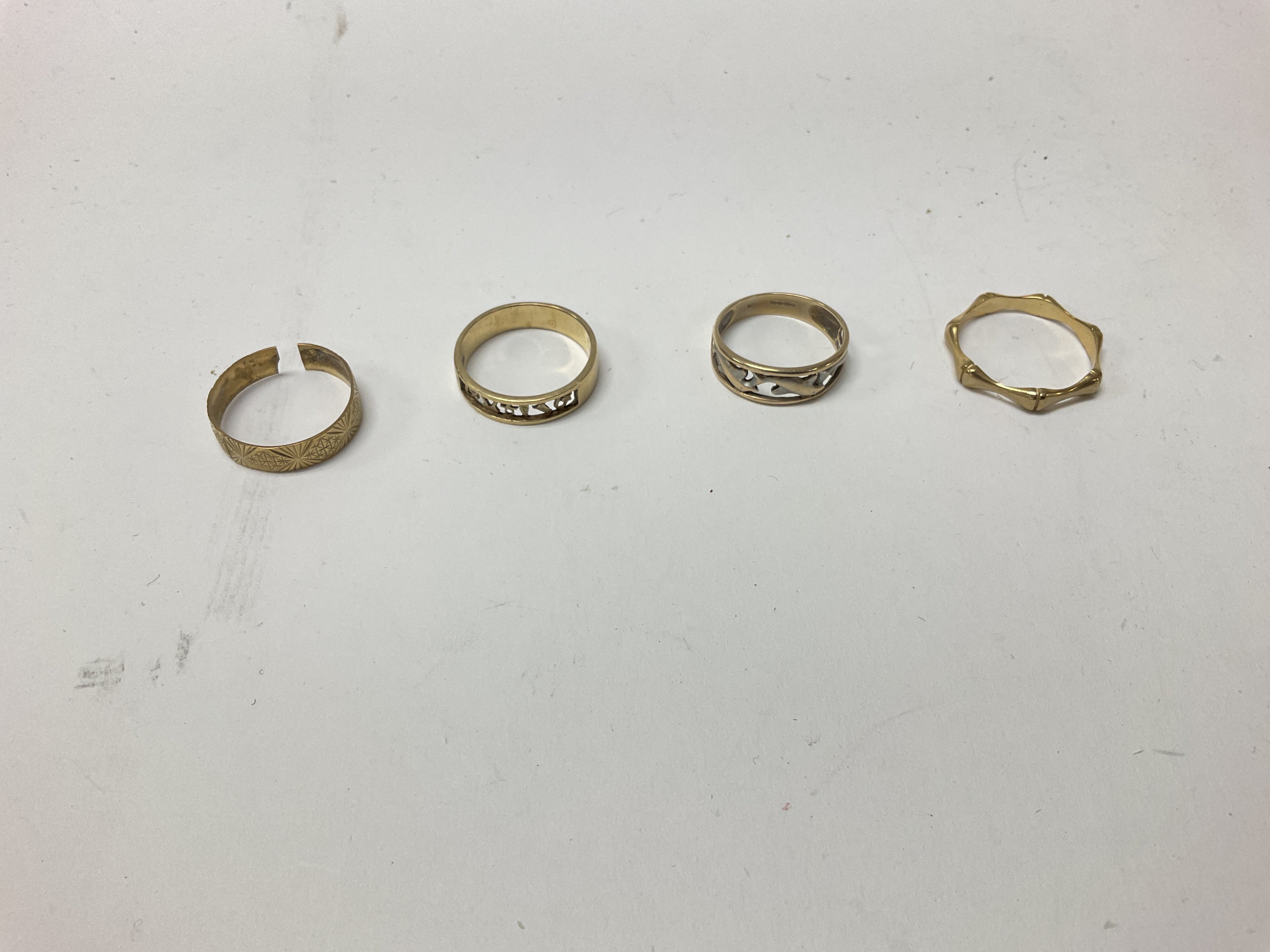 Four 9ct gold bands, approx weight 9.7 grams