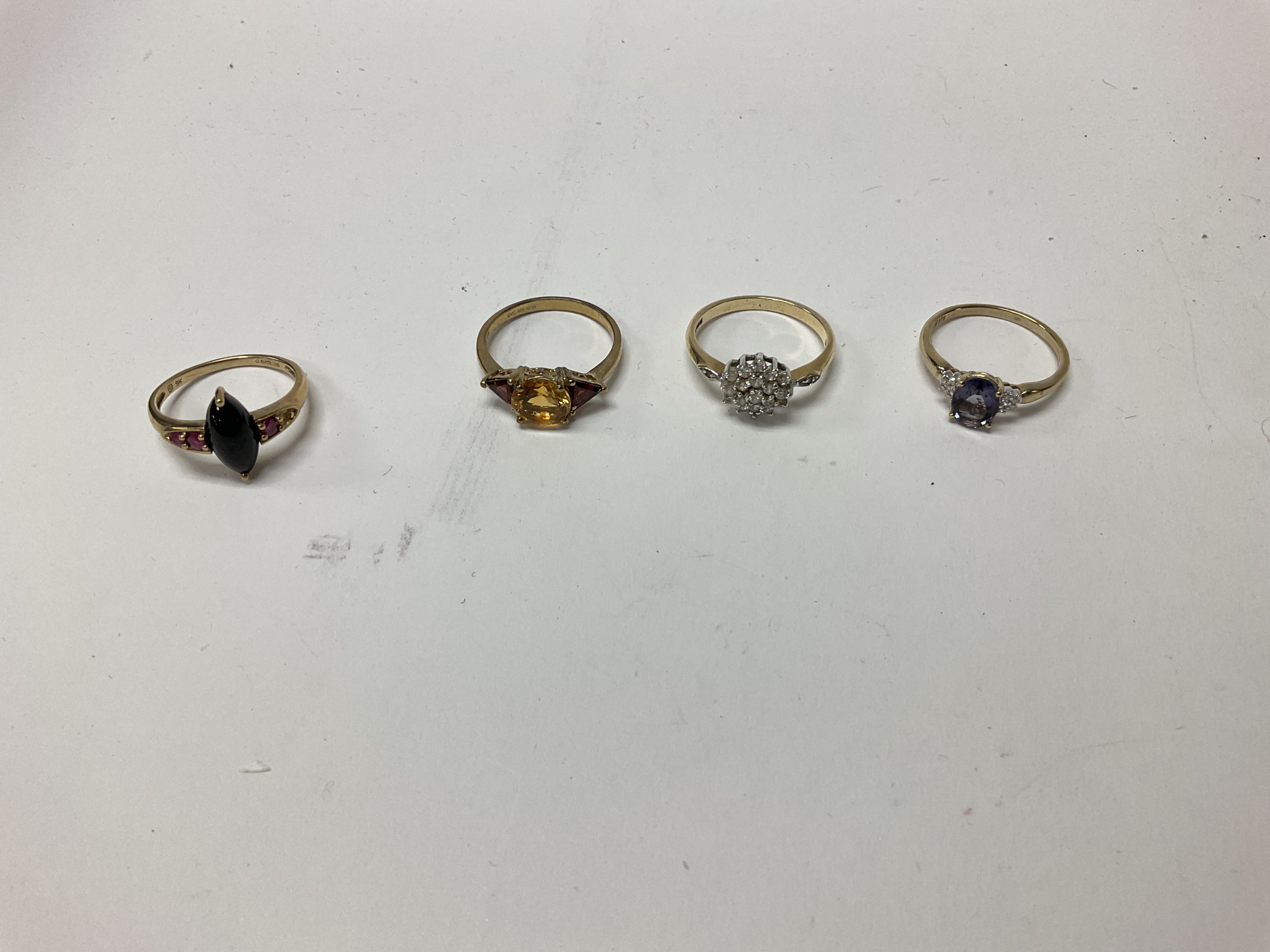 Four 9ct gold stone set rings, approx weight 9.62 grams.