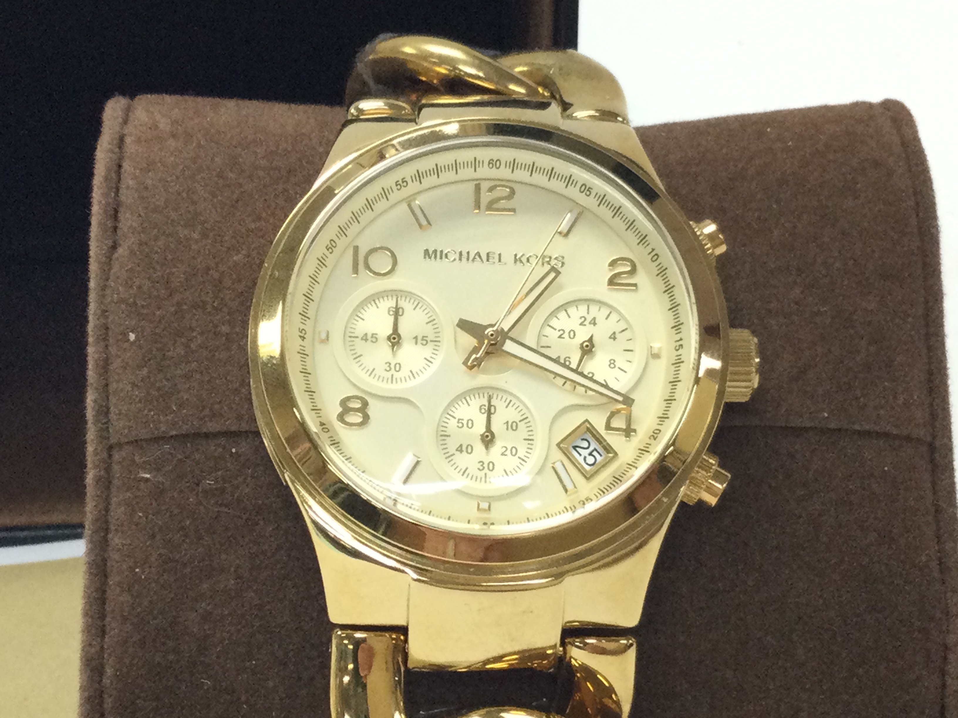 A Michael Kors yellow watch on curb link bracelet. With paperwork and seen running. Postage B