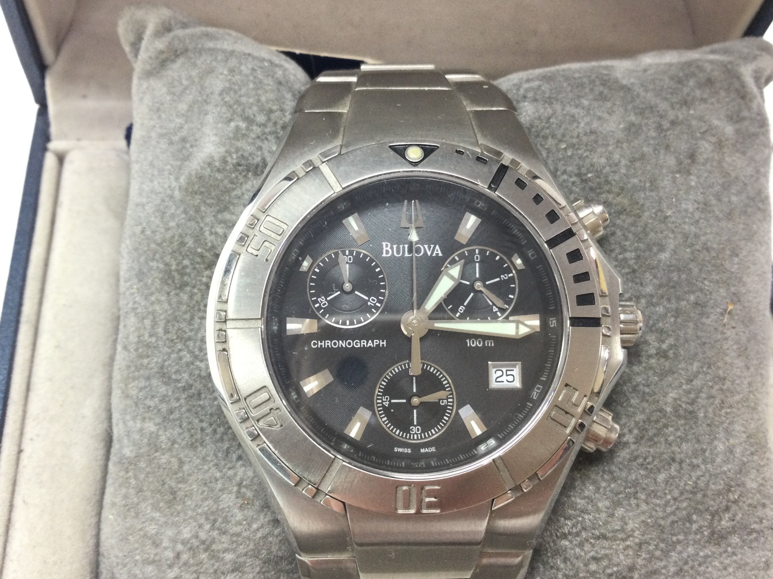 A Bulova stainless steel Chronograph with black dial. Comes with box and papers and seen working. Postage B