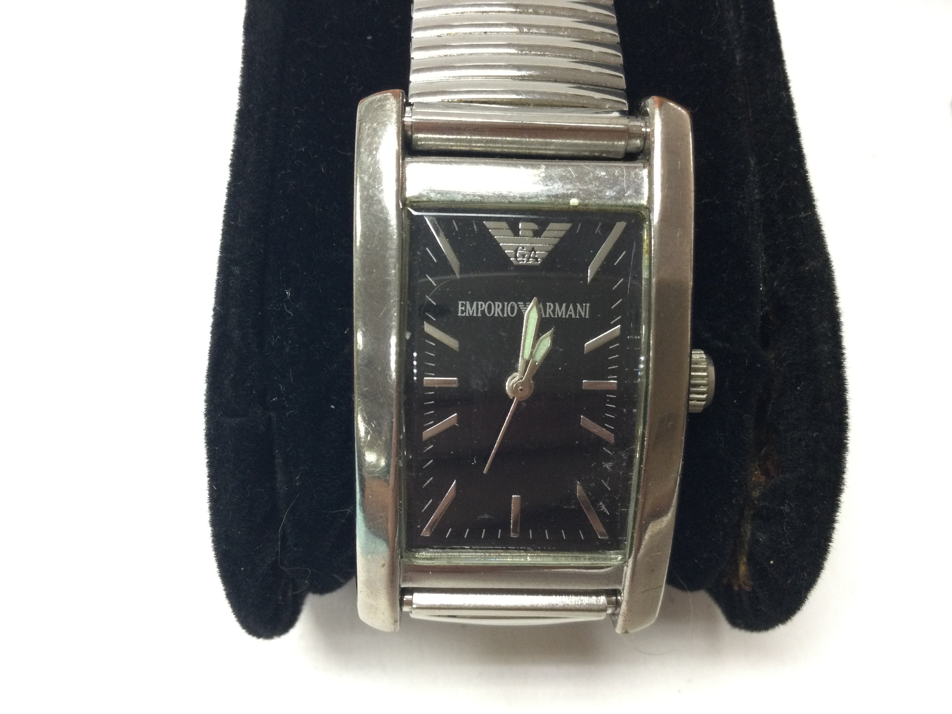 A stainless steel Emporio Armani watch on stretch bracelet. Seen running. Comes with box and papers. Postage B