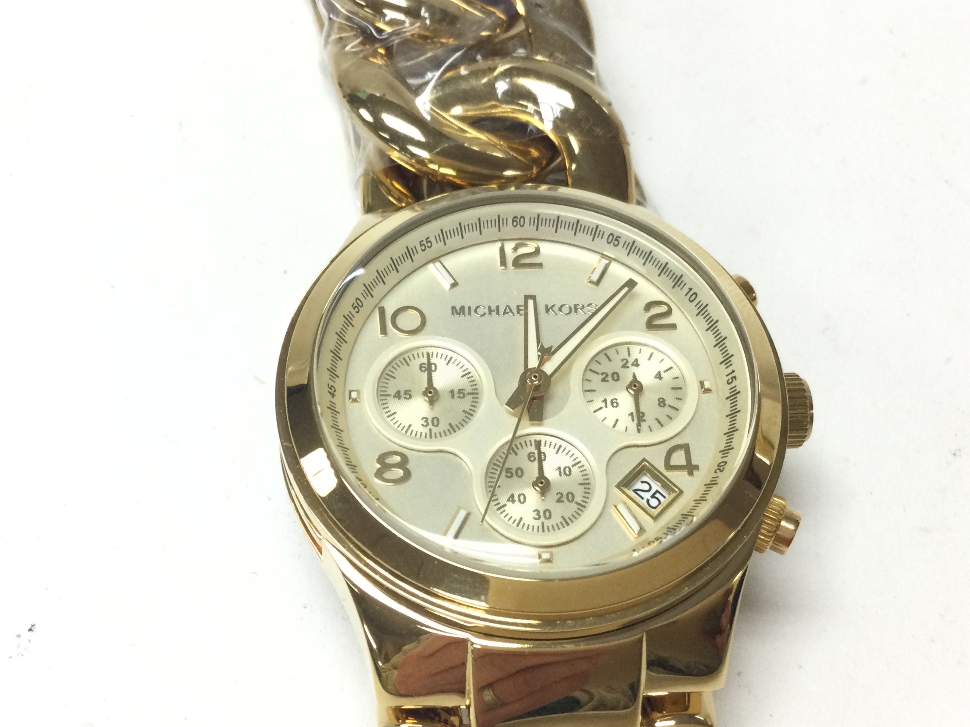 A Michael Kors yellow watch with a curblink bracelet. Seen working and in as new condition. Postage B