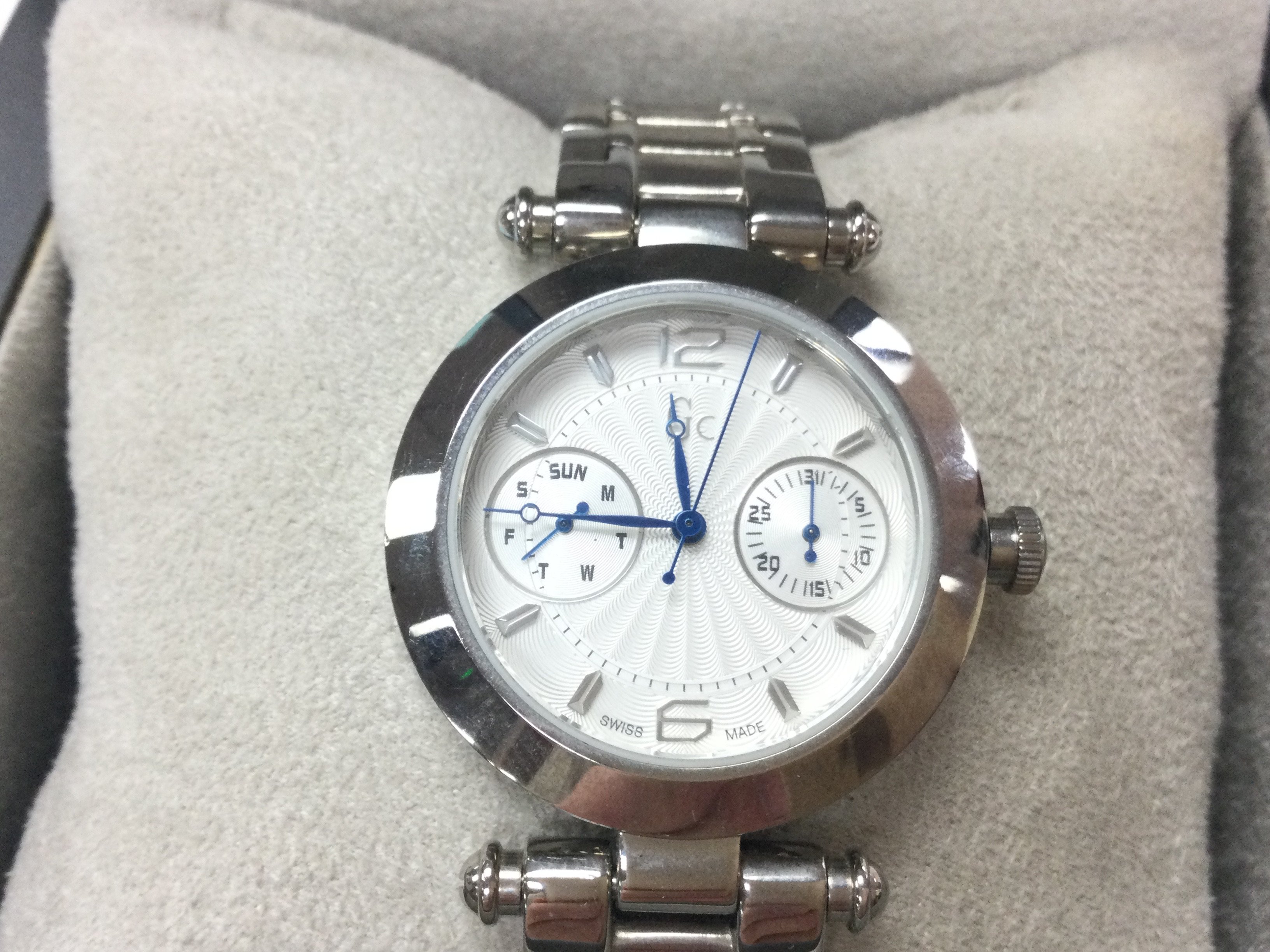 A GC ladies watch in stainless steel. Round face with white / silver dial with box and cards. Seen running. Postage B