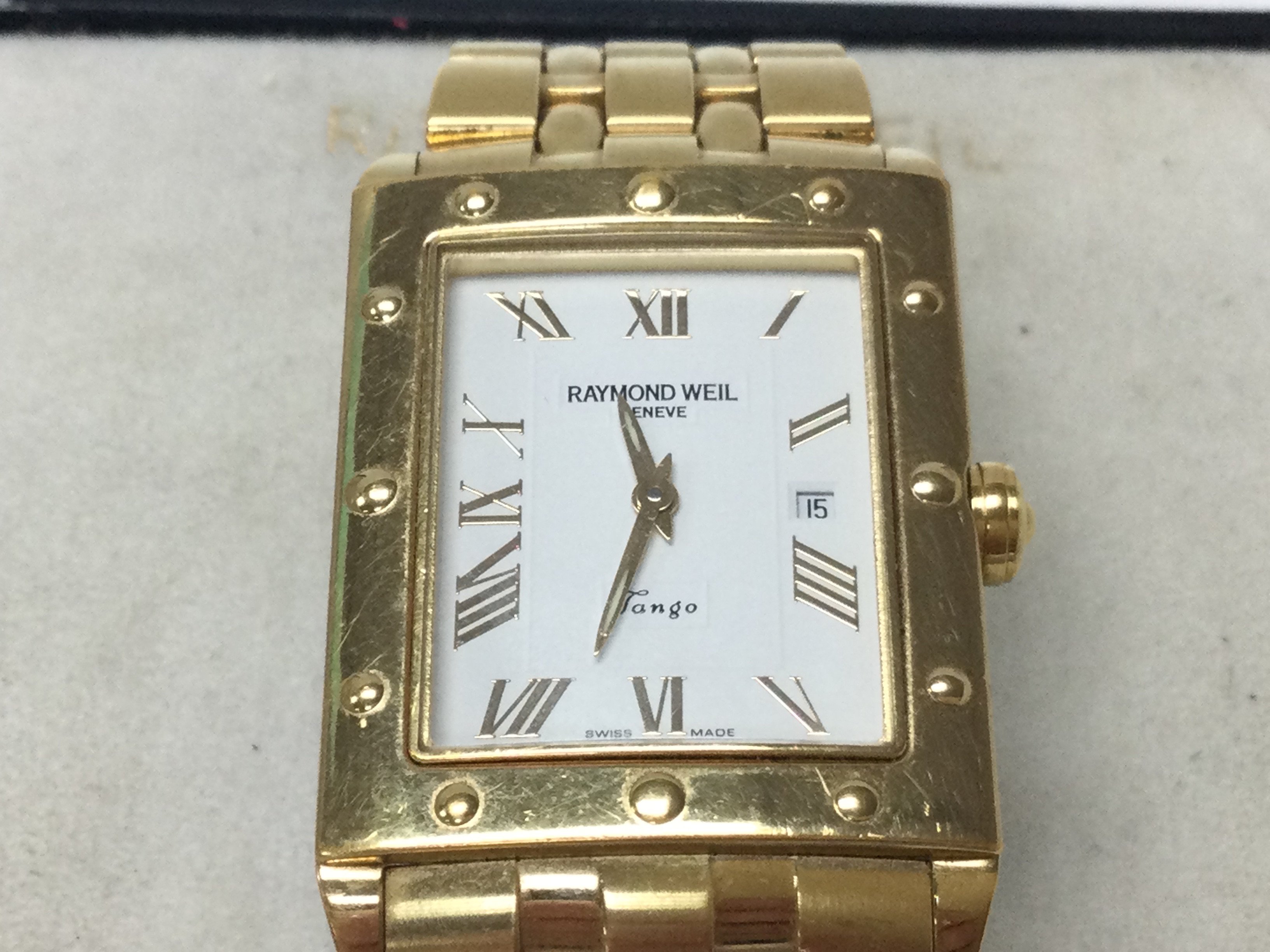 A Raymond Weil white dial tango gold plated watch. Come with box. Postage B