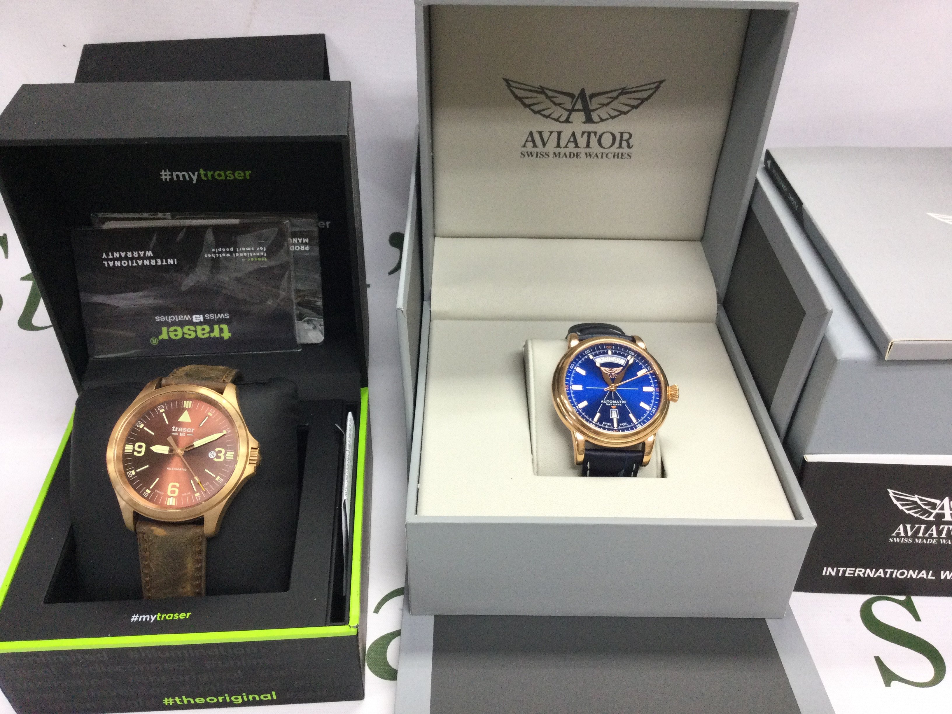 An Aviator Swiss made day date gents automatic watch and one other. Both in boxes with paperwork. Postage B