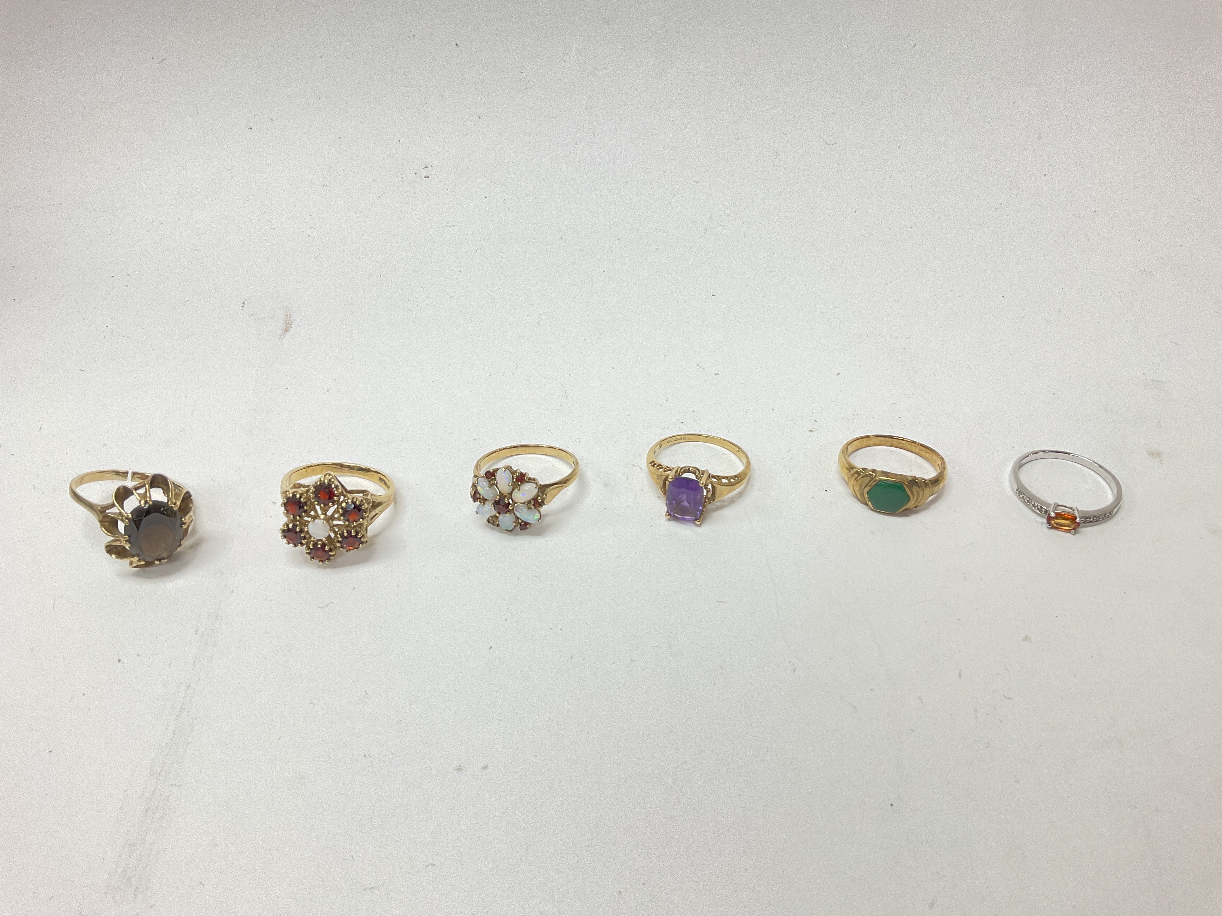 Six 9ct gold stone set ring, approx weight 19.41 grams.