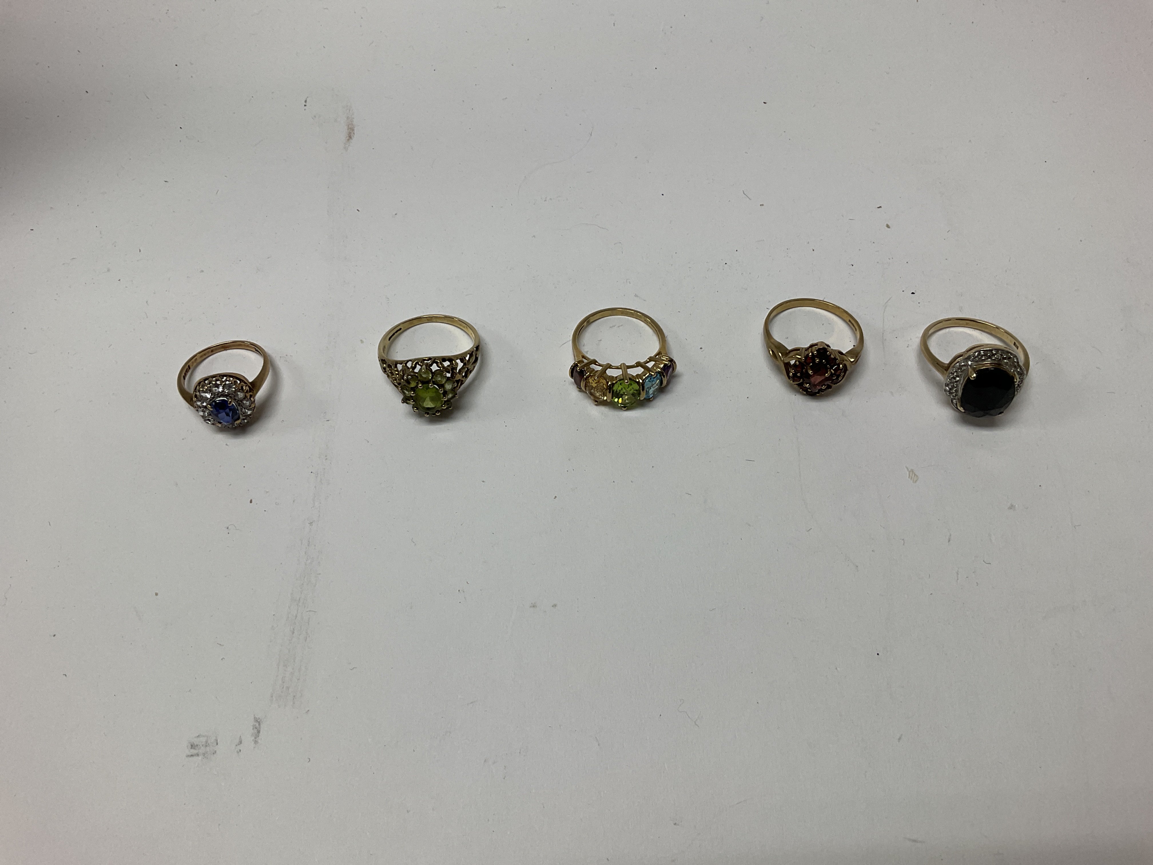Five 9ct gold stone set rings, approx weight 17.4 grams.
