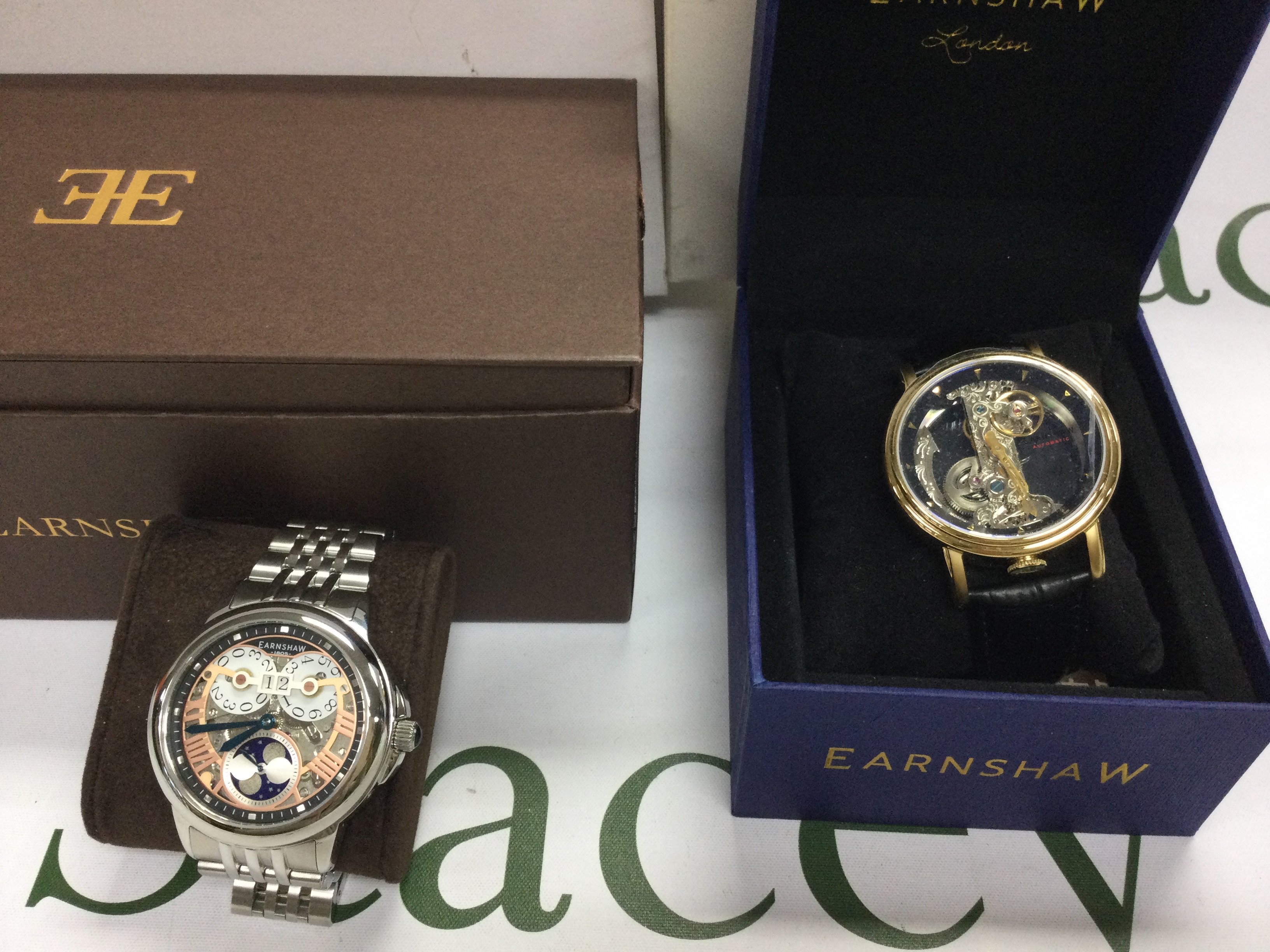 Two Earnshaw automatic wrist watches including a moon phase version. Both in boxes and seen running. Postage B