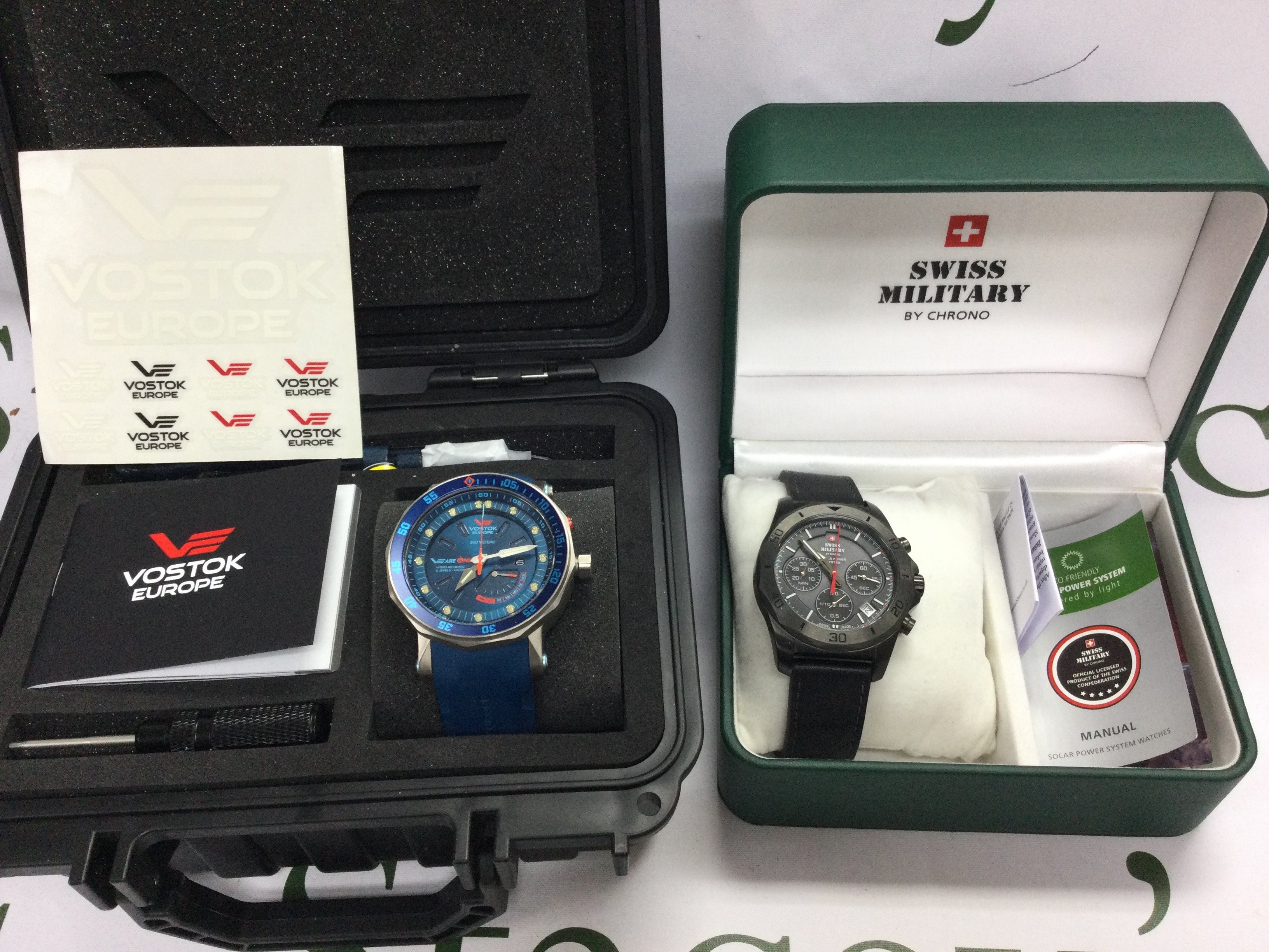 A Vostok Europe watch with box and papers and one other. Postage B