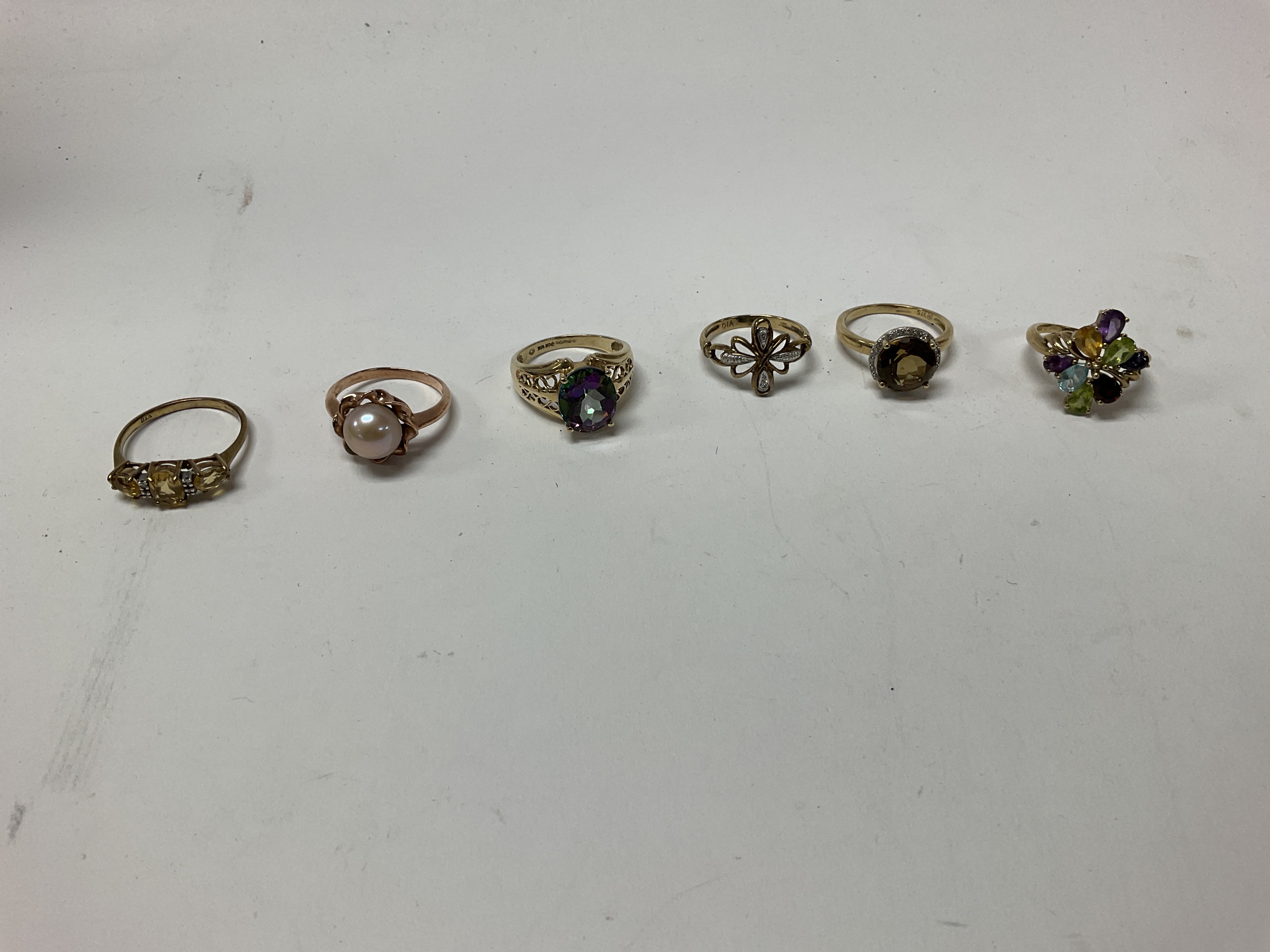 Six 9ct gold stone set rings, approx weight 19.38 grams.