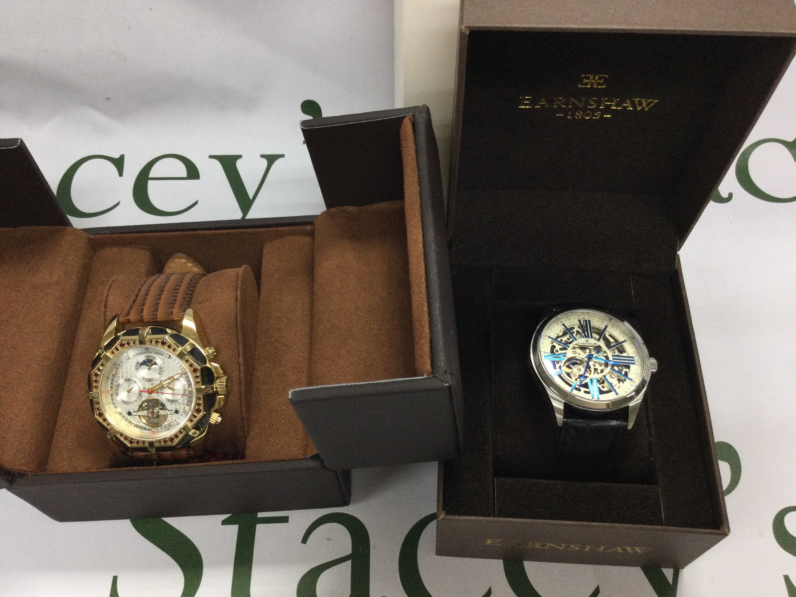 A Earnshaw automatic wrist watch and a Constantin Weisz watch including boxes both seen running. Postage B