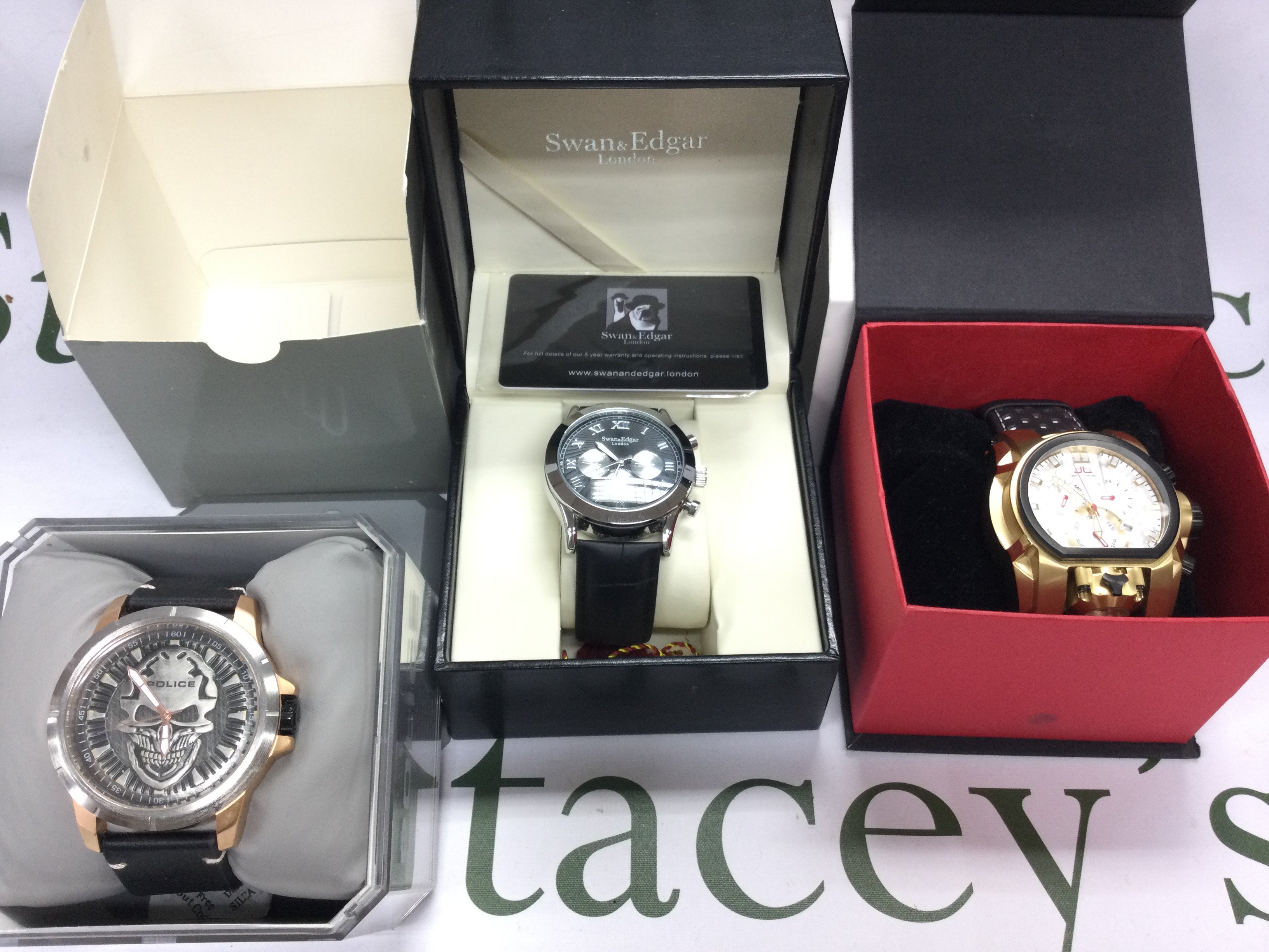 Three watches including police DeLorean and Swan and Edgar. All with boxes. Postage B