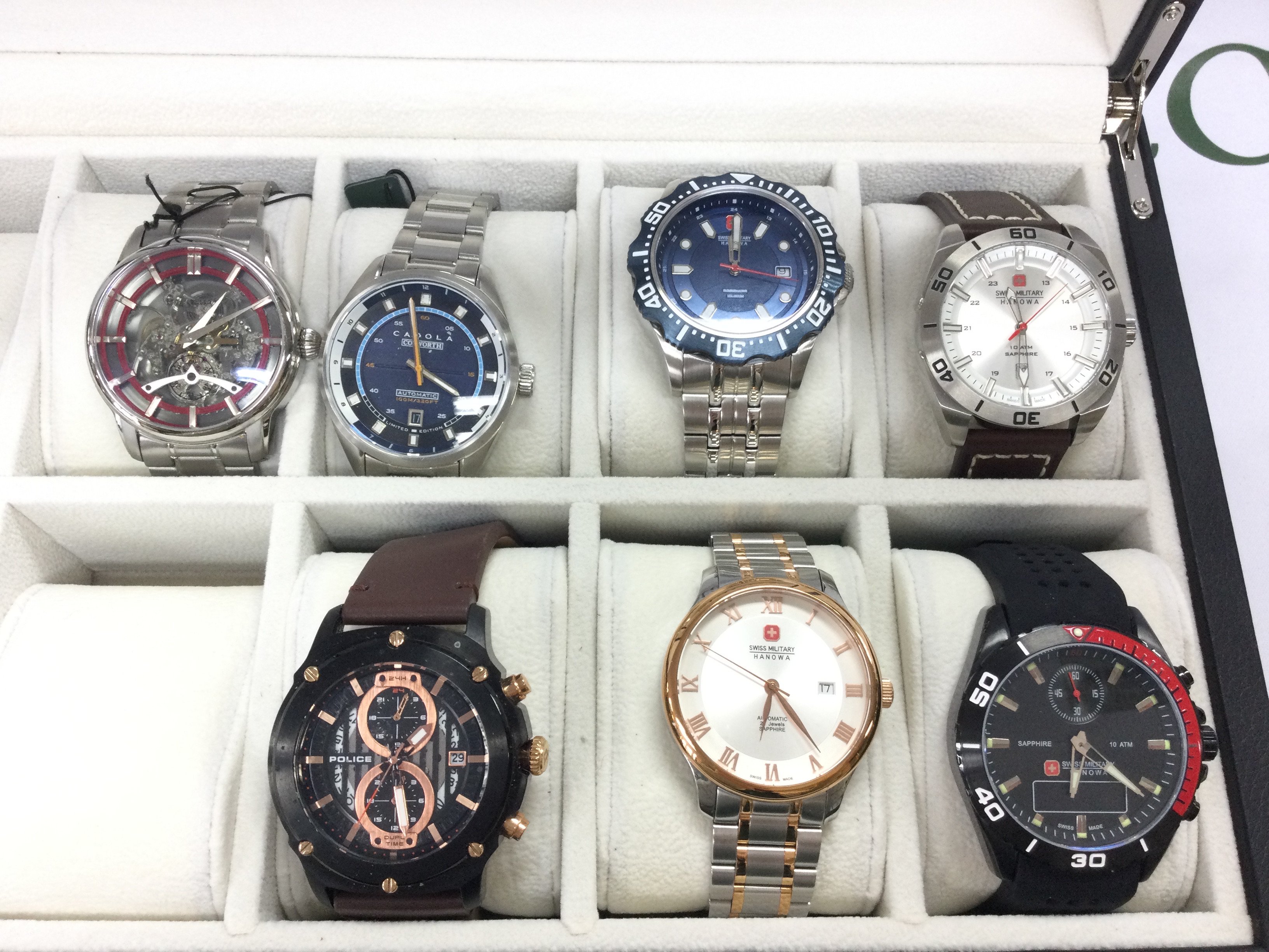 A small collection of watches including Swiss military and police etc all in a 10 watch storage box. Postage B