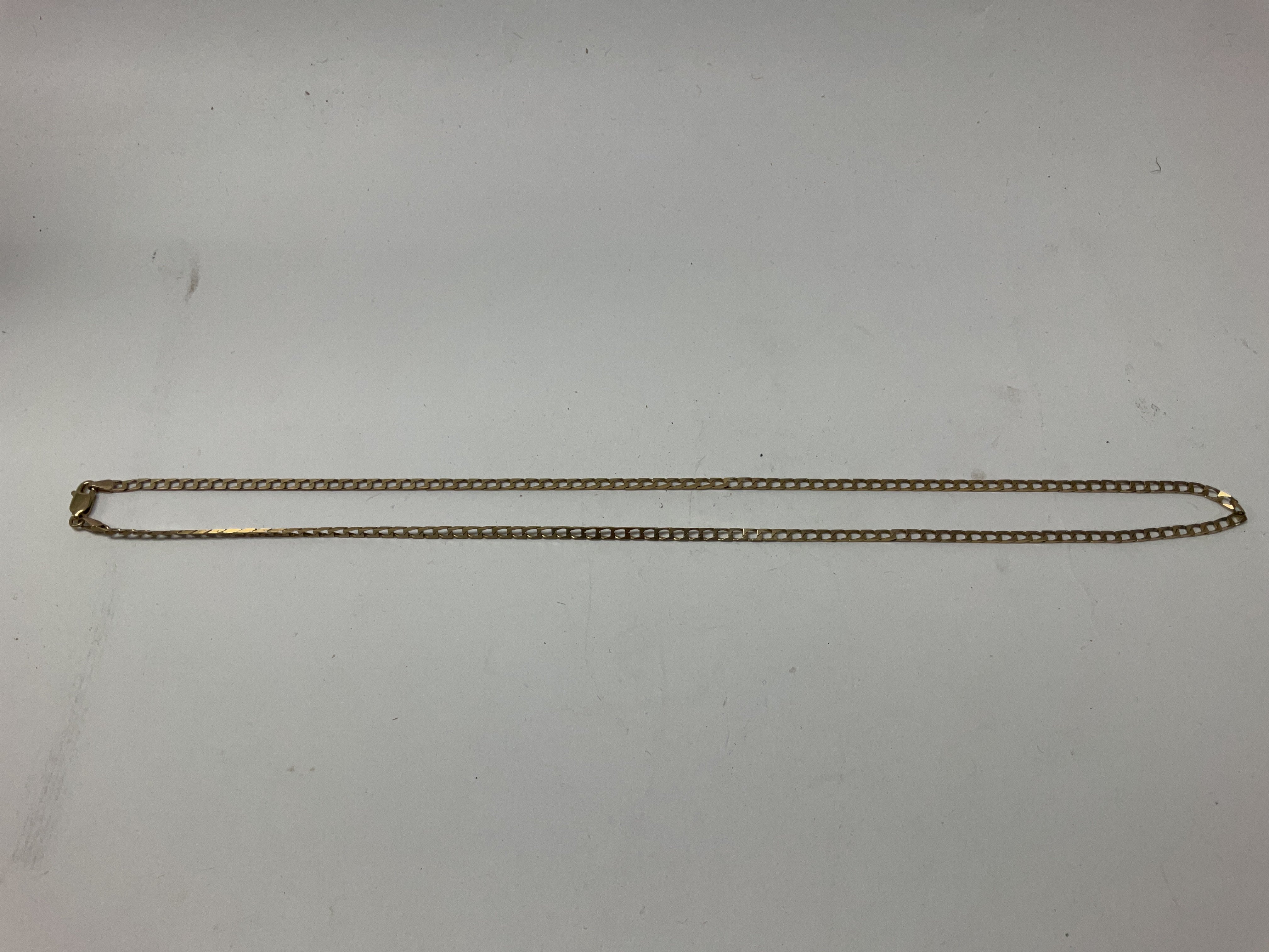 A 9ct gold flat square curb link bracelet, approx weight 5.8 grams. Approx length 20 inches.