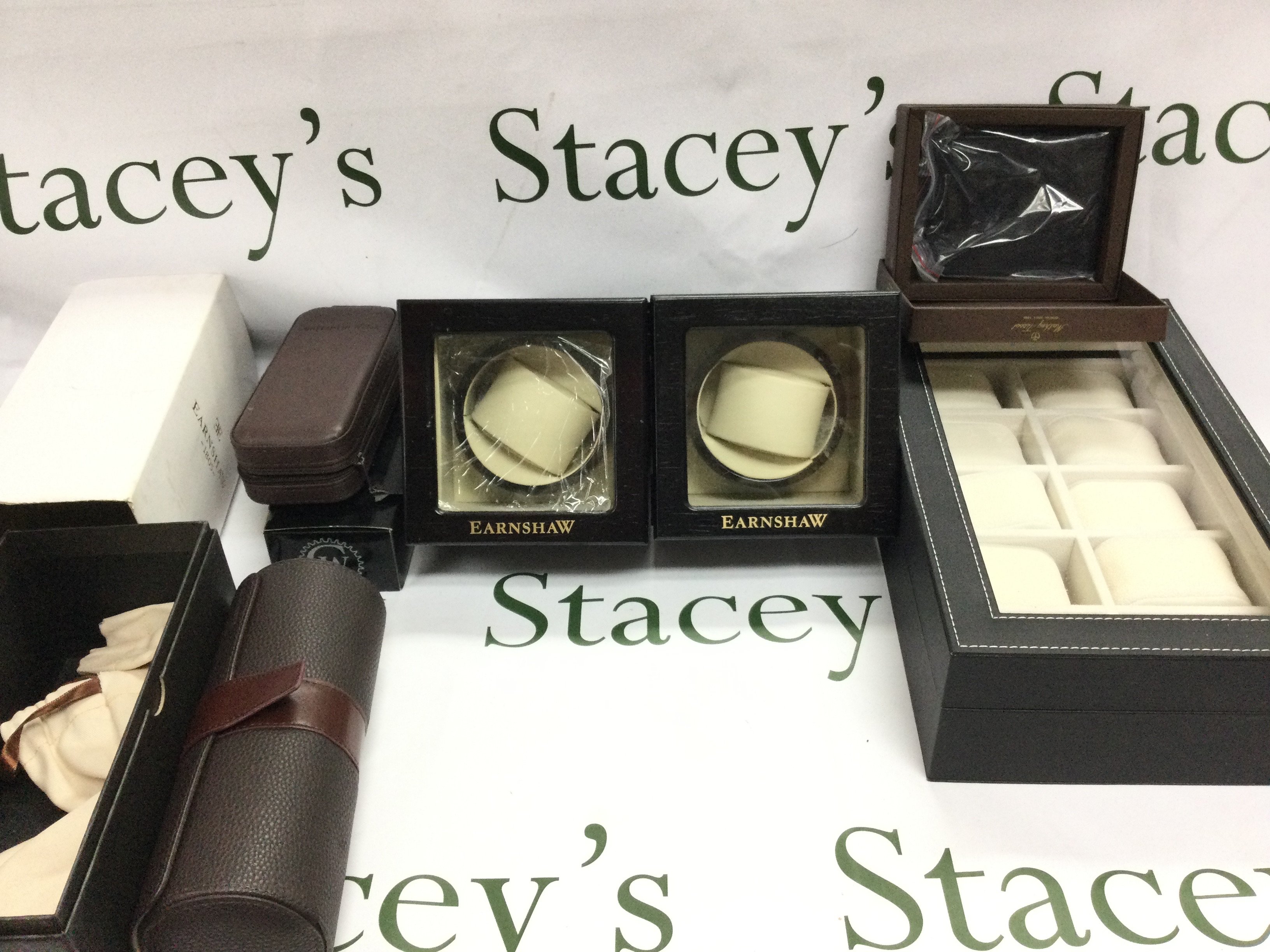 A collection of Watch accessories including to watch winders a travel watch roll and a 10 watch box etc. Postage B