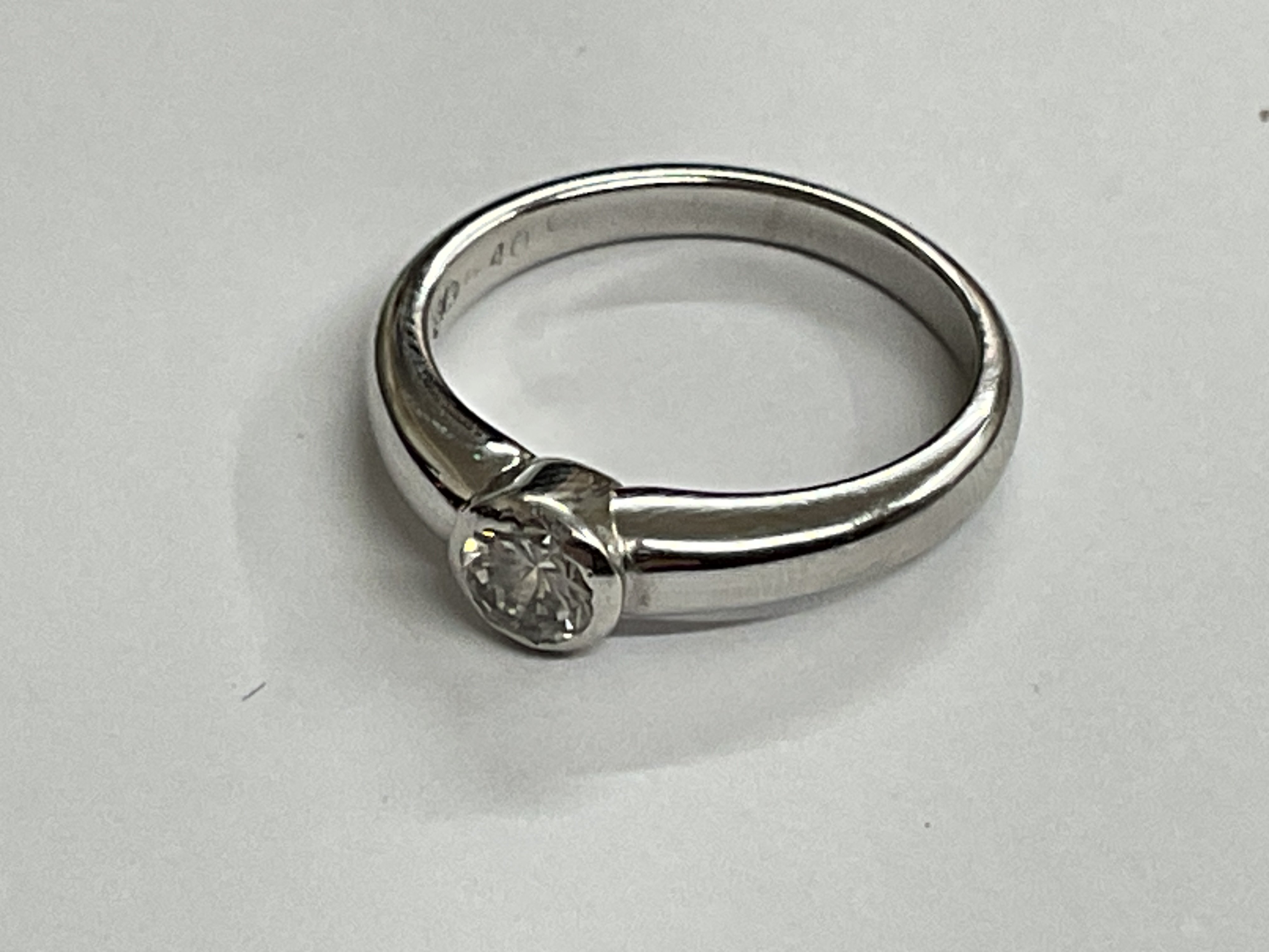 18ct white gold single stone rub over set ring. Approx ring size J. 0.40ct, 3.52g. Postage category A.