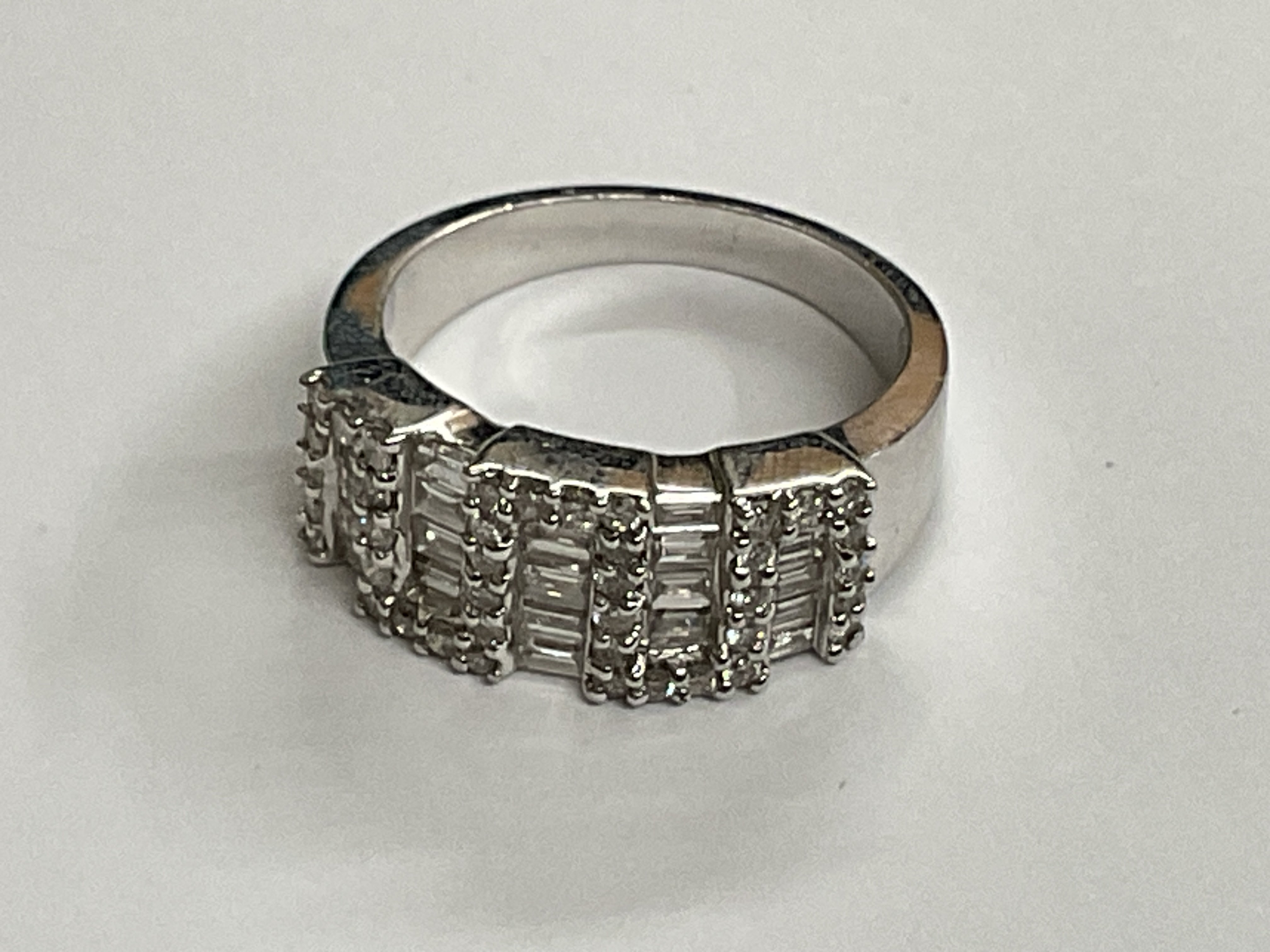 18ct white gold baguette round diamond. 1.30ct, 7g. Ring size approx M. Postage category A.