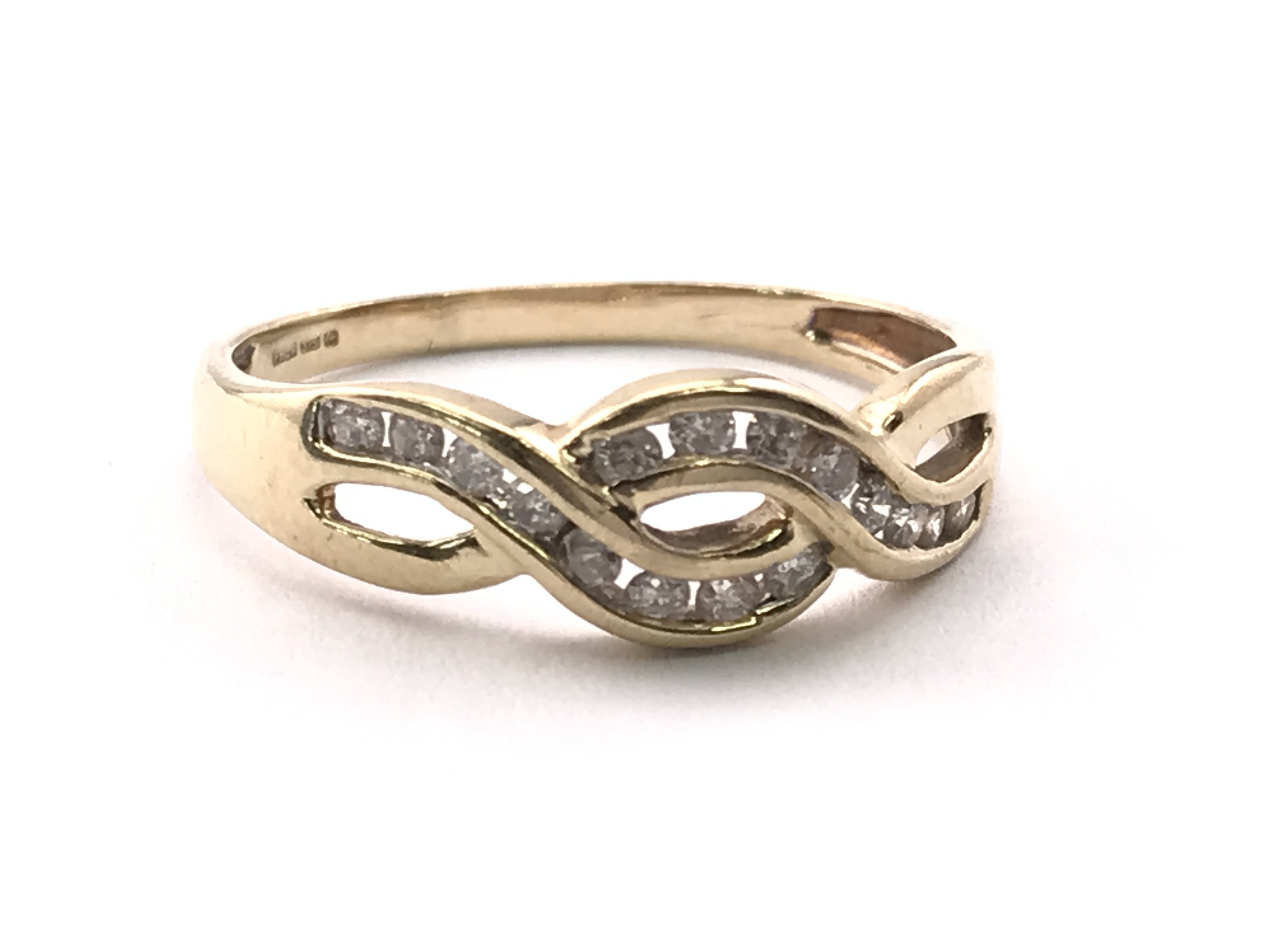 A 9ct gold twist ring, inset with small diamonds. Ring size N/O. 1.95g Postage category A