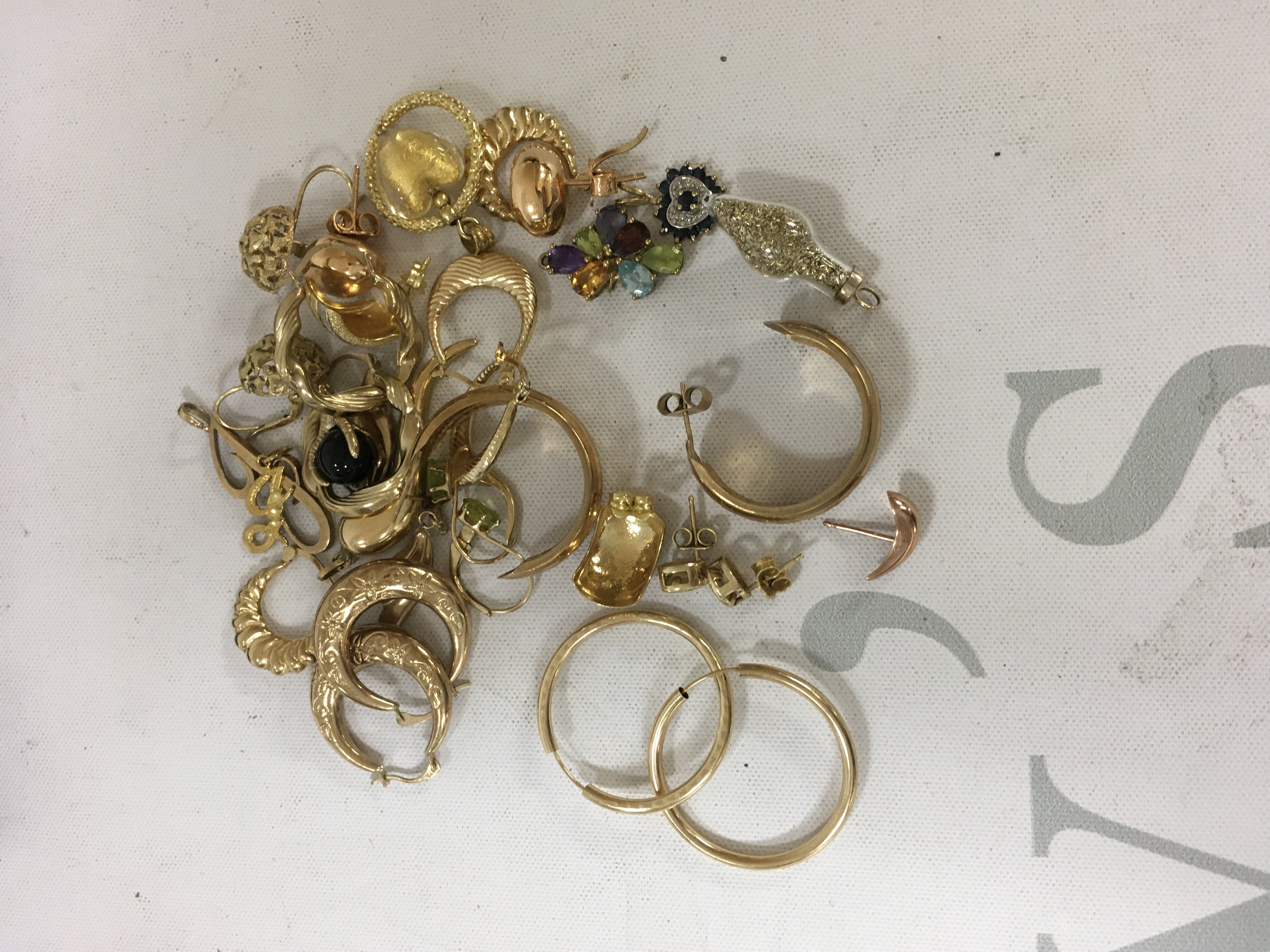 A collection of 9ct gold charms and earrings. Approx weight 26.80 grams.