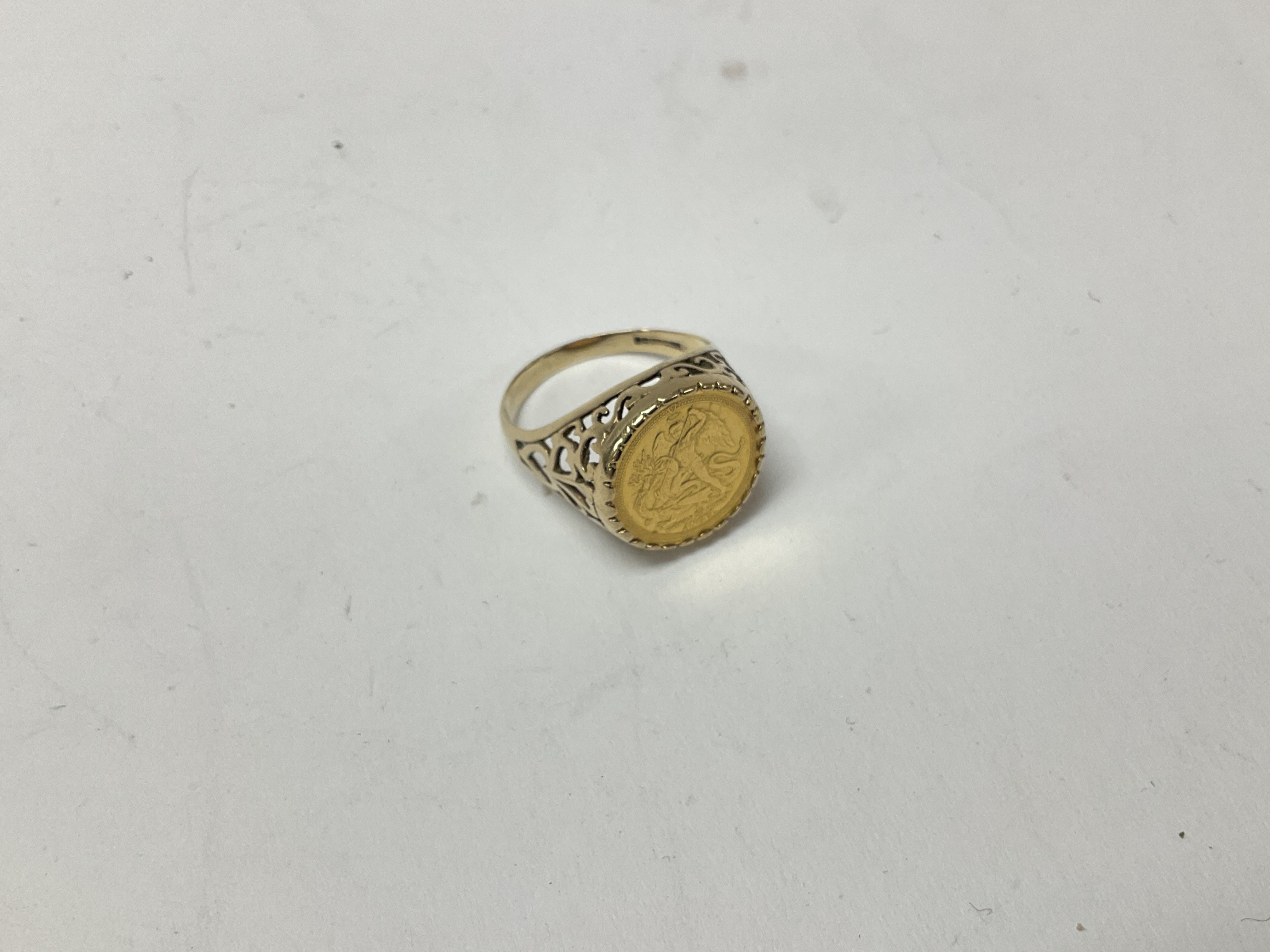 A 9ct gold coin set ring approx weight 4.8 grams. Size R.