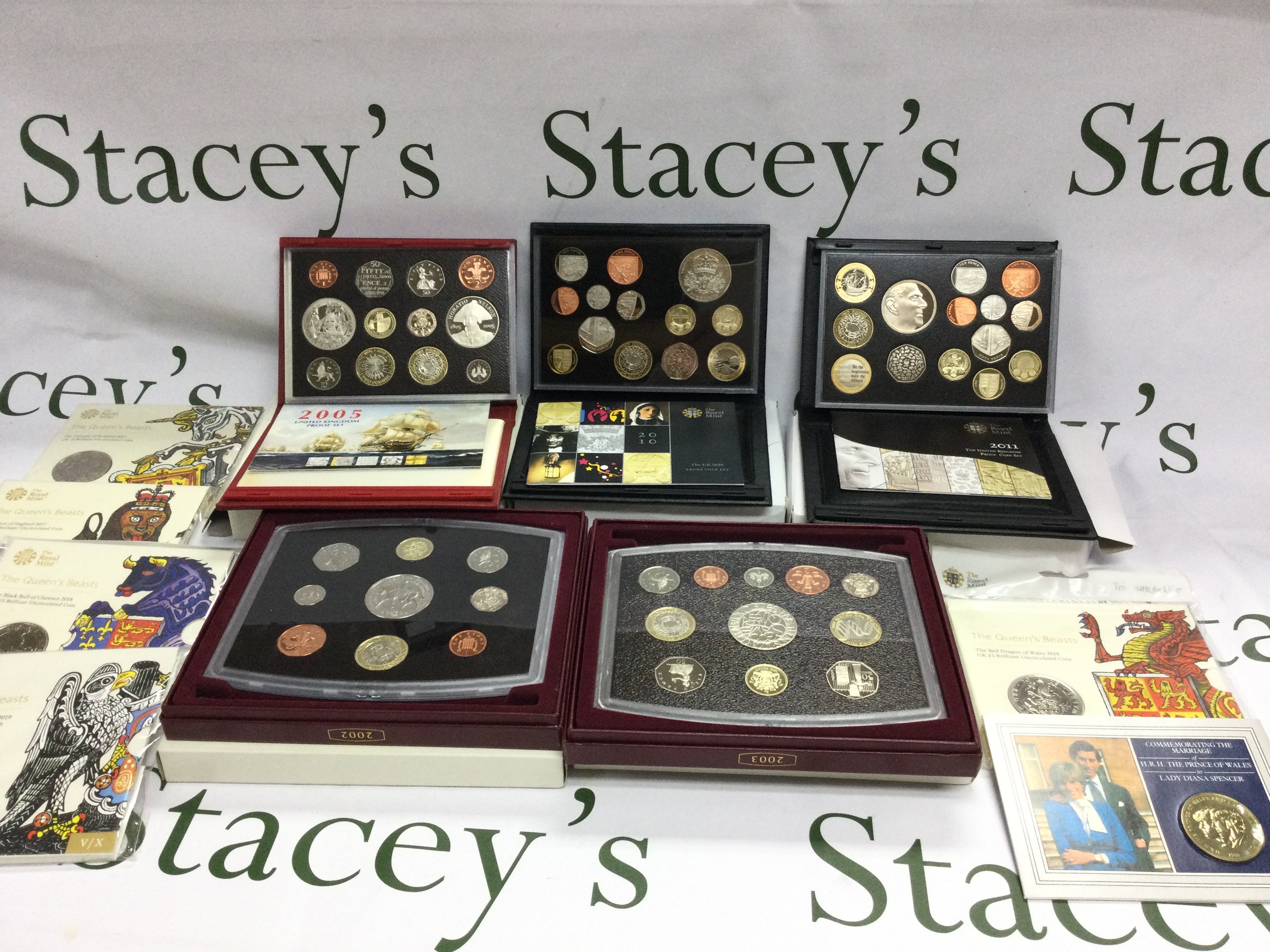 A collection of 5 United Kingdom proof coin sets and 5 queen beast &pound;5coins etc. Postage B