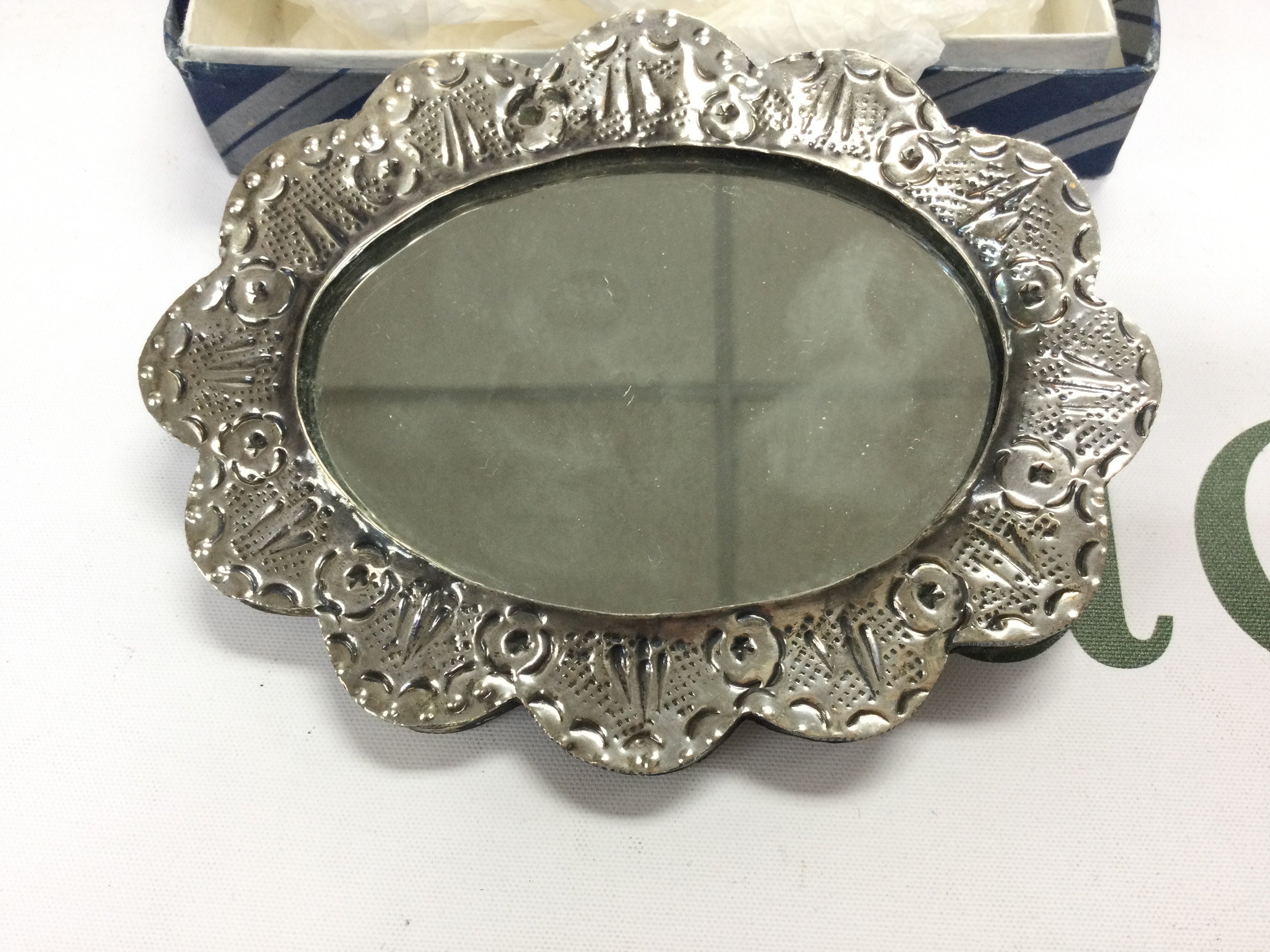 A small silver hand mirror possibly Persian. 13.5cm wide.