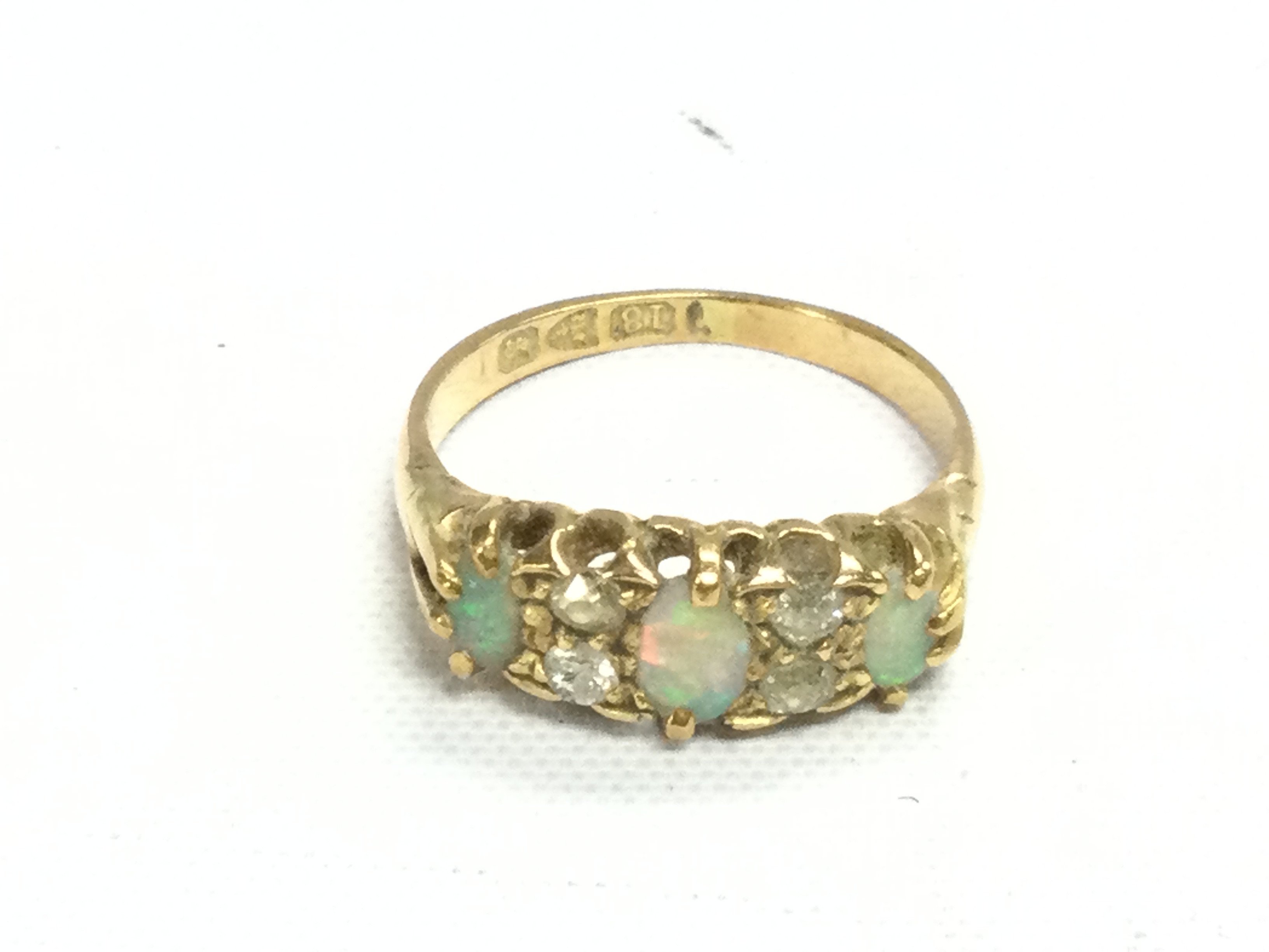 An 18ct gold opal and diamond ring. Size N 1/2 and 3.46g Postage A
