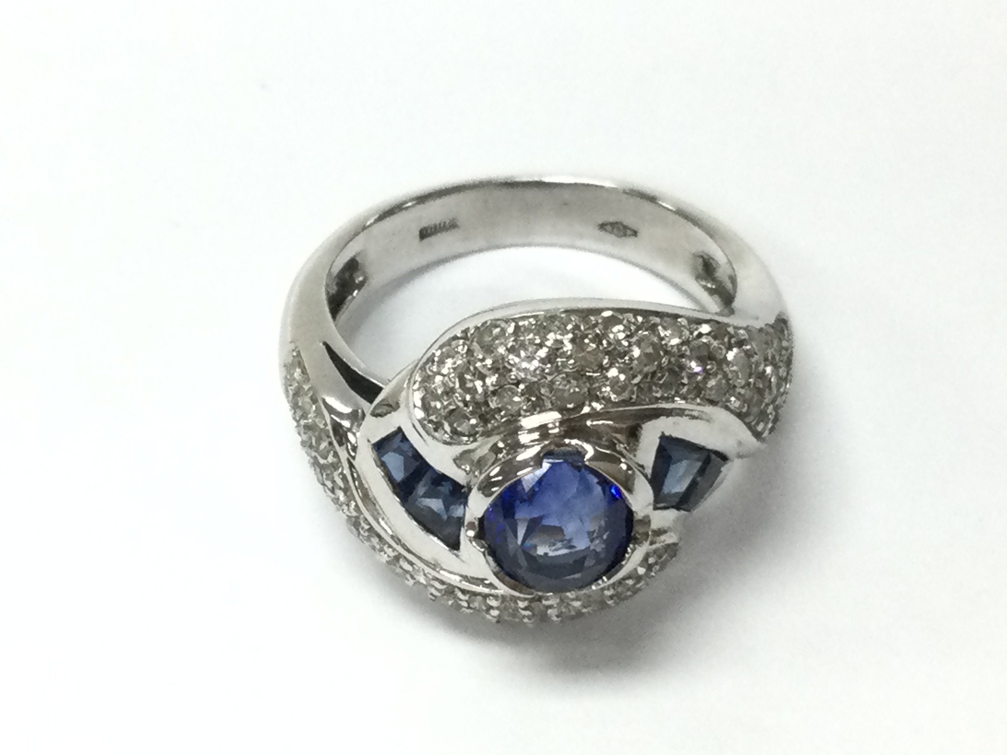 An 18ct white gold ring set with sapphires and diamonds. Size J and 6.90g. Postage B