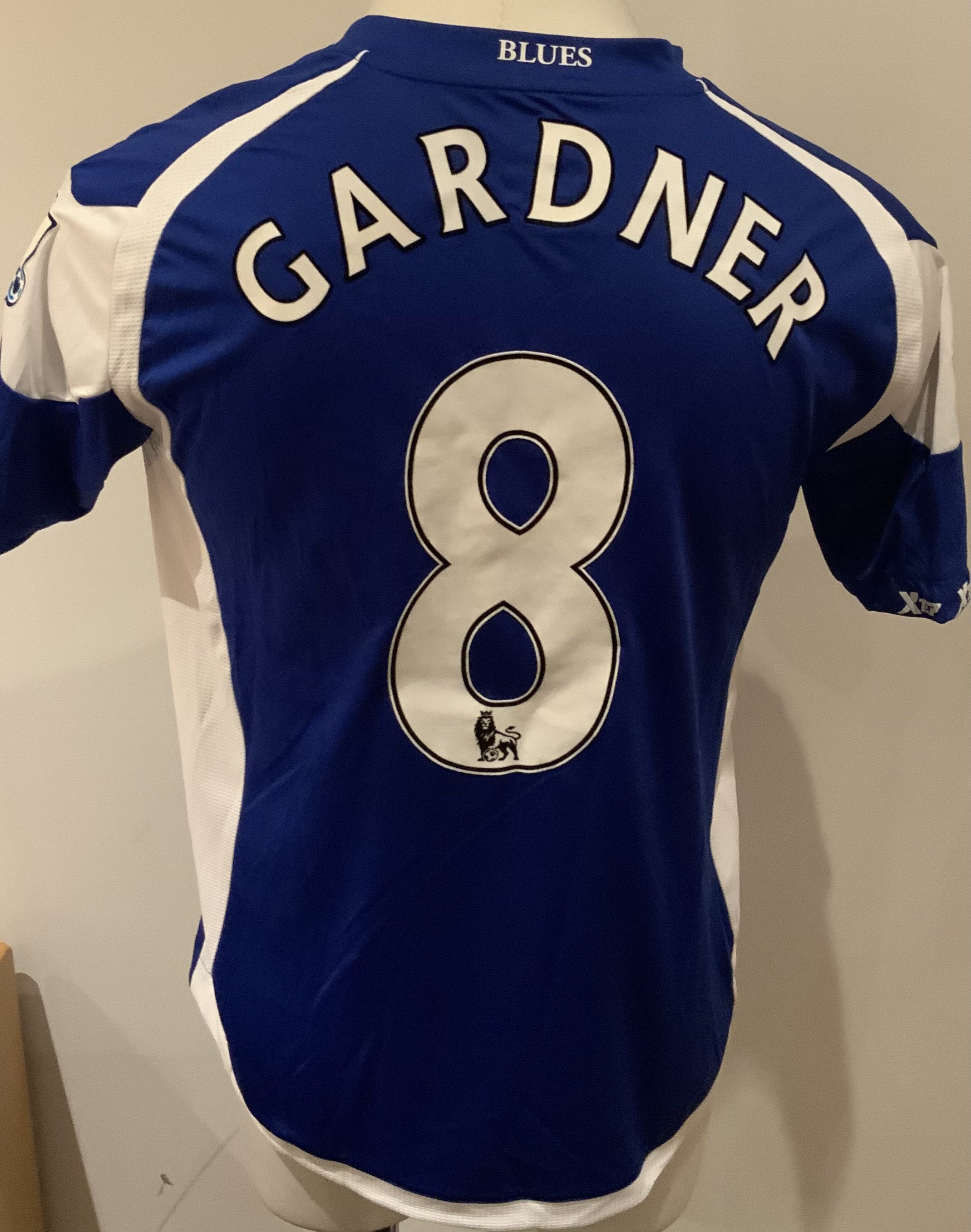 Birmingham City 2010 - 2011 Match Worn Football Shirt: Blue short sleeve shirt with Premier League badges to sleeves. Gardner 8 to rear. Worn v Tottenham on 22 May 2011. Gardner scored for Birmingham in this match.