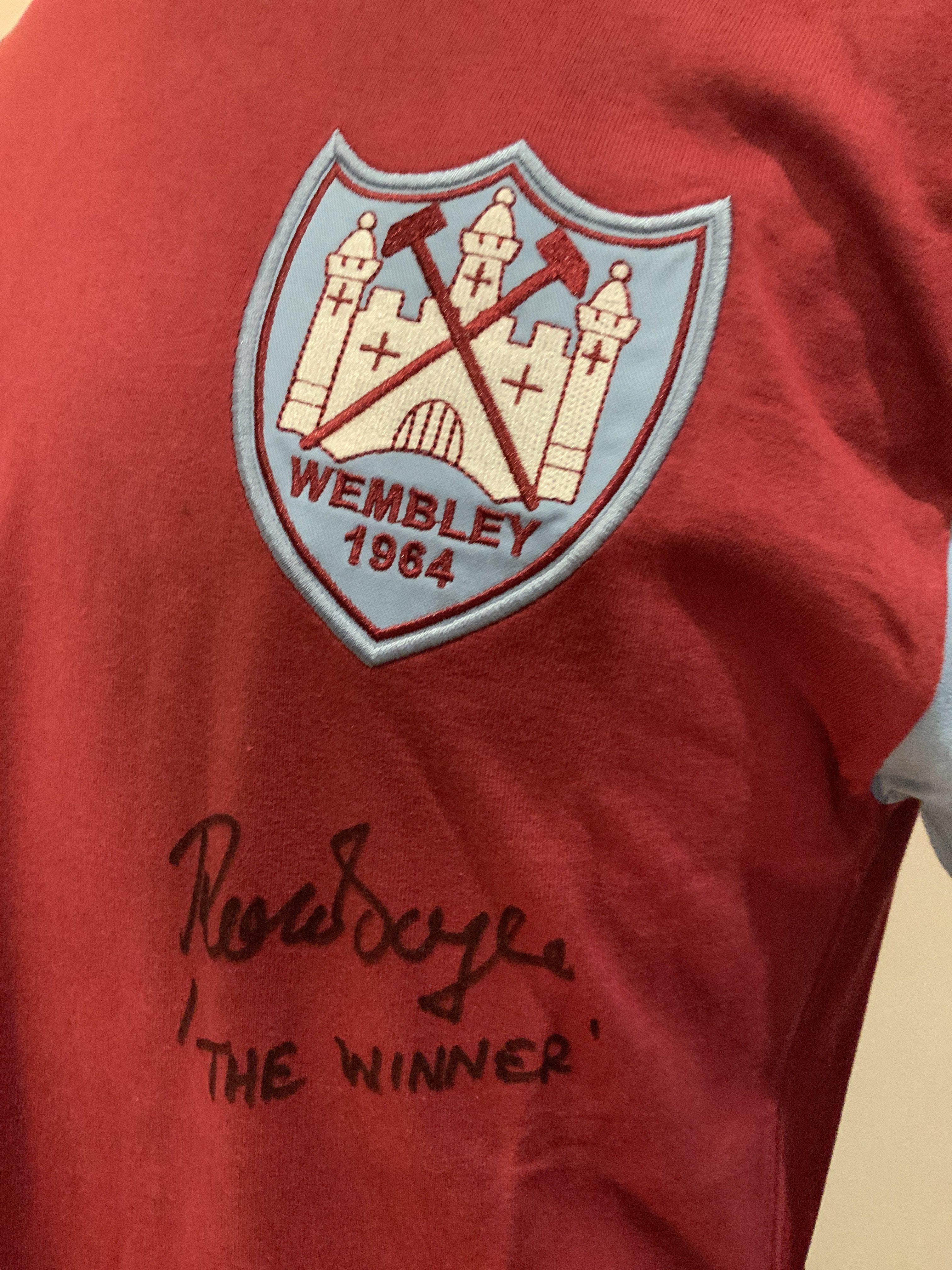 1964 West Ham FA Cup Final Signed Replica Shirt: Long sleeve signed to front by Ron Boyce. COA from reputable source. Boyce has signed The Winner with reverence to his 90th minute winning goal. 