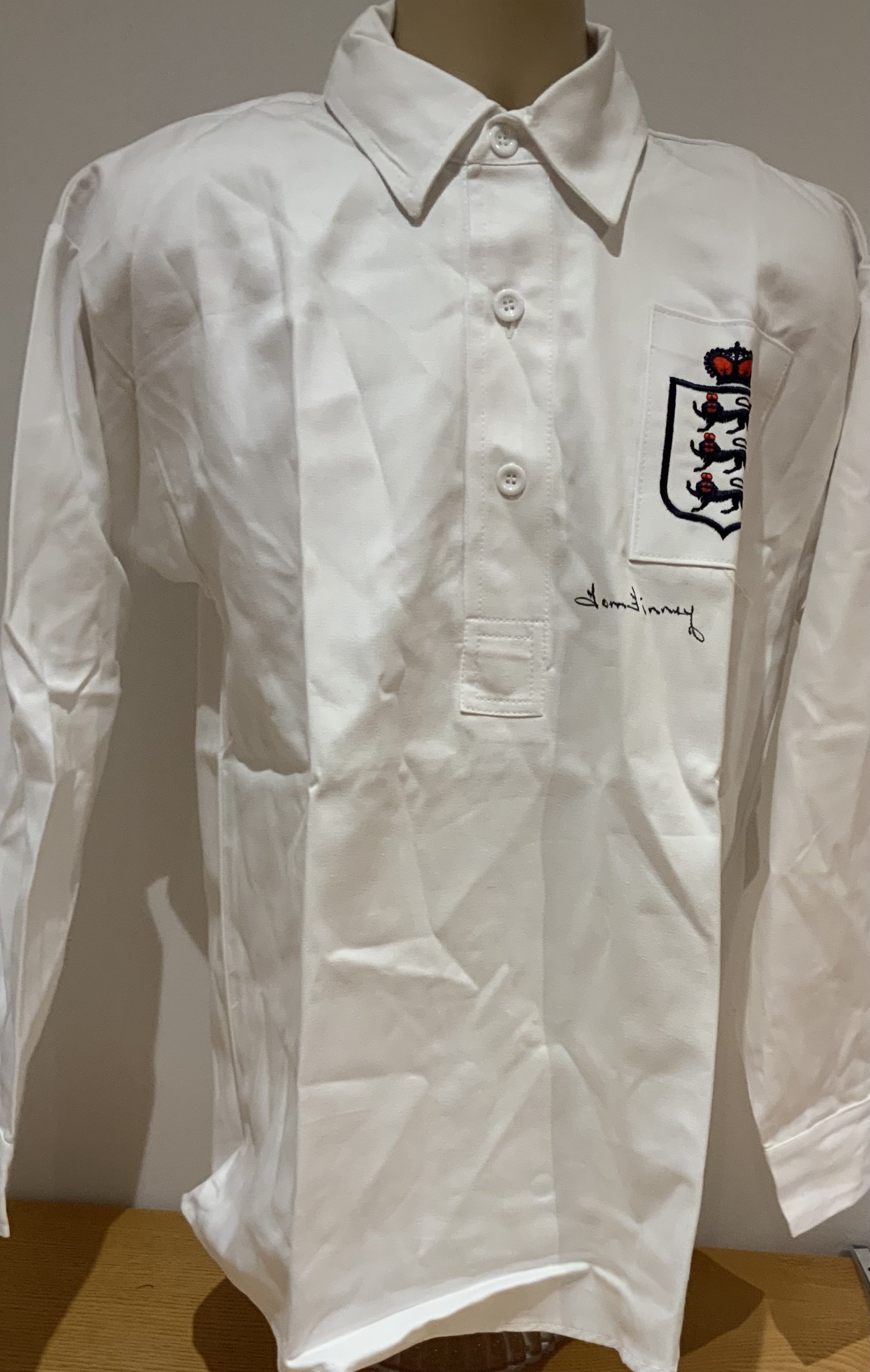 To Finney England Signed Replica Shirt: Collated old style retro shirt signed to front by Tom Finney. COA from reputable source. 