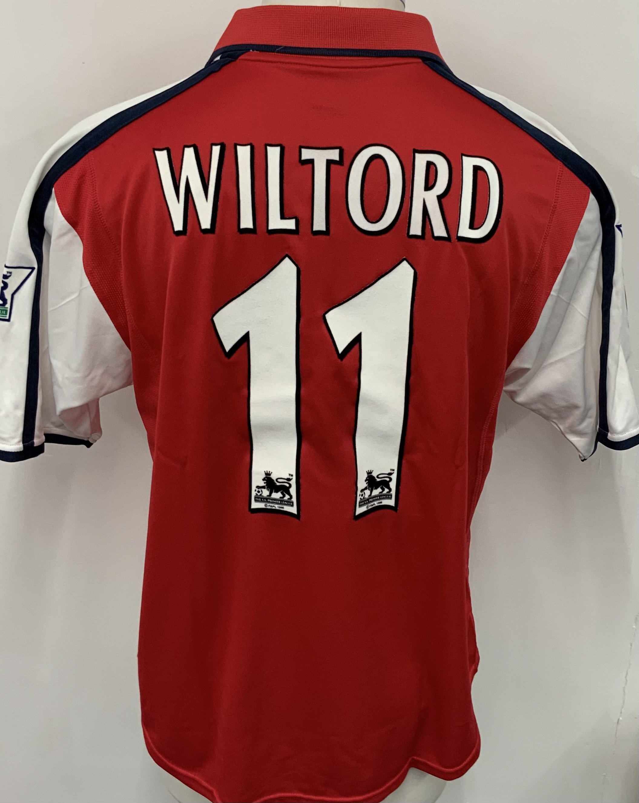 Arsenal 2000 - 2001 Home Match Worn Football Shirt: Red and white short sleeve  Nike Dreamcast shirt with Premier League badging to sleeves. Wiltord 11 to rear. Worn v Manchester City on 28 October 2000. Comes with signed COA from the player who scored in the match.
