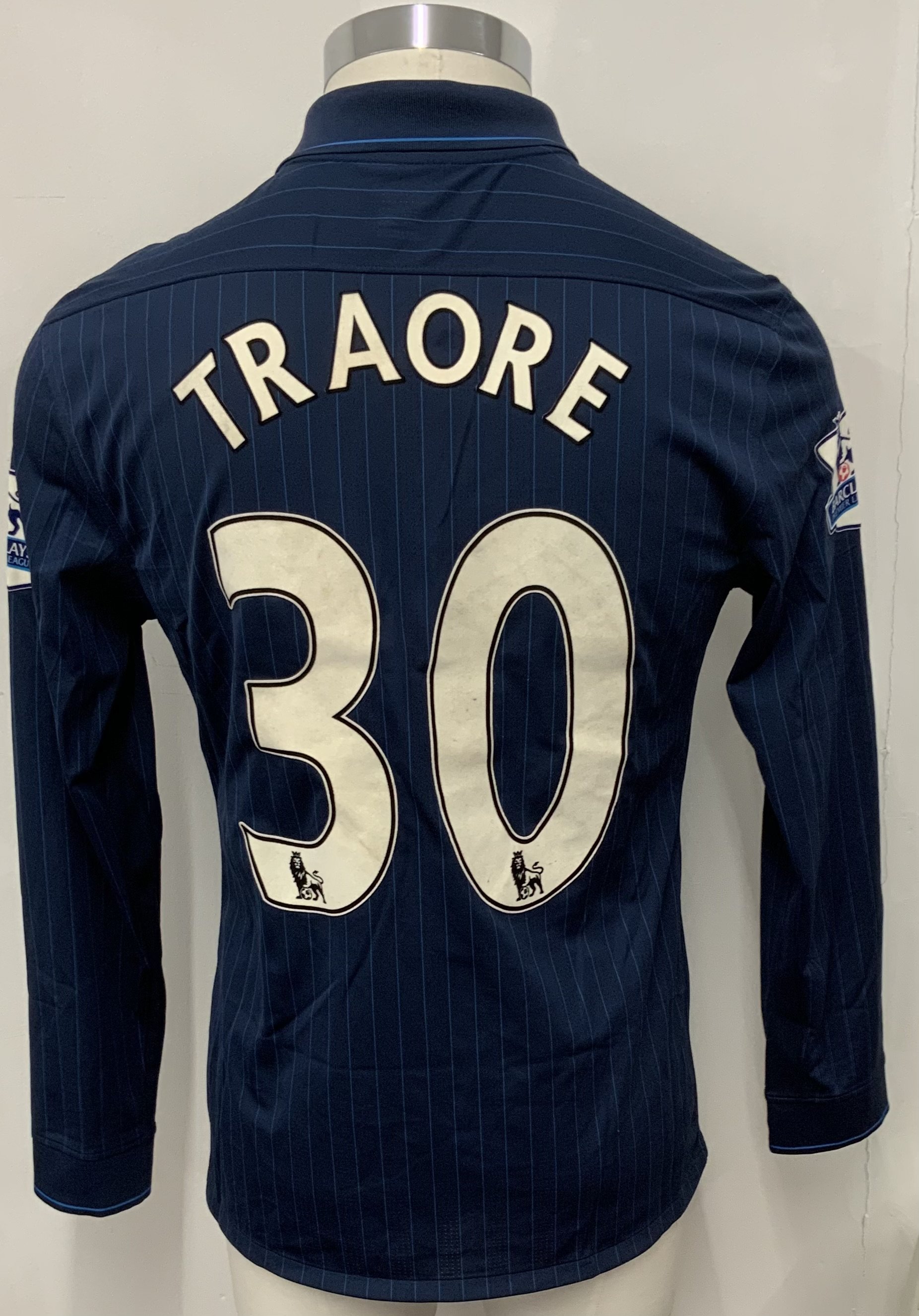 Arsenal 2009 - 2010 Away Match Issued Football Shirt: Blue pin striped long sleeve Nike shirt with Premier League badging to sleeves. Traore 30 to rear.