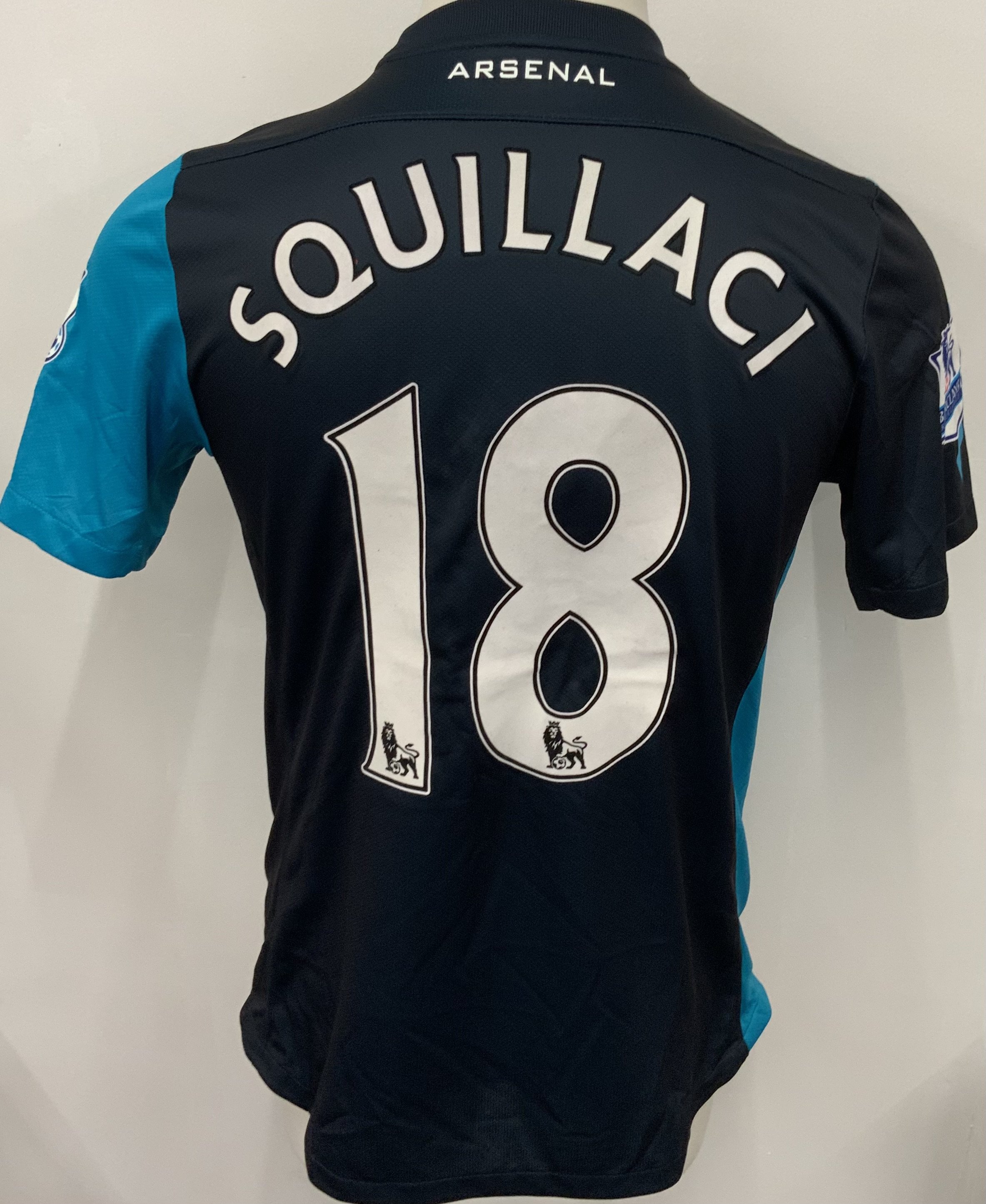 Arsenal 2011 - 2012 Match Issued Football Shirt: Blue short sleeve Nike shirt with Premier League badging to sleeves. Squillaci 18 to rear.