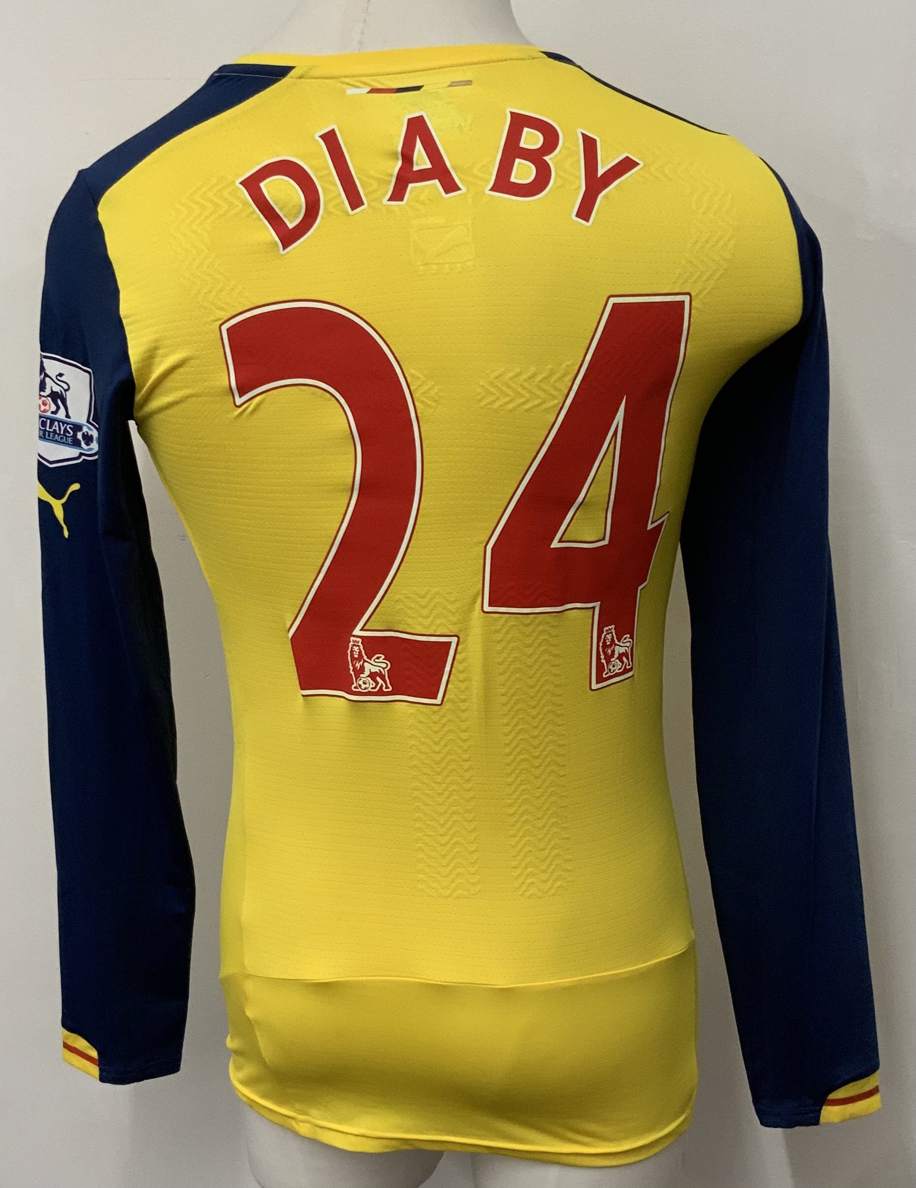 Arsenal 2014 - 2015 Home Match Worn Football Shirt: Yellow long sleeve Nike shirt with Premier League badging to sleeves. Diaby 24 to rear.