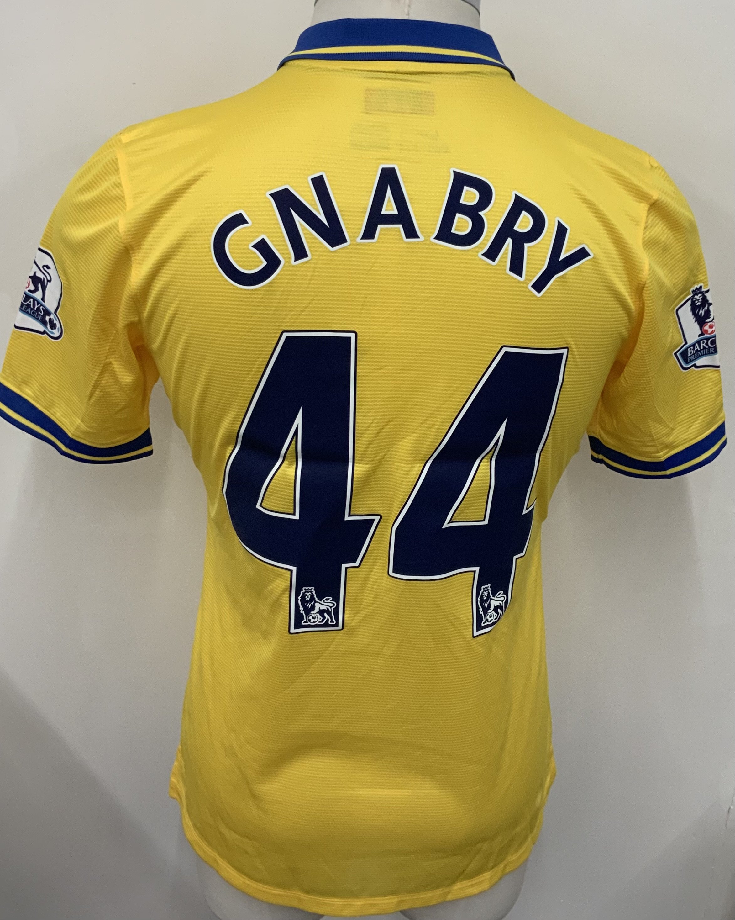 Arsenal 2013 - 2014 Away Match Issued Football Shirt: Yellow short sleeve Nike shirt with Premier League badging to sleeves. Gnabry 44 to rear. 