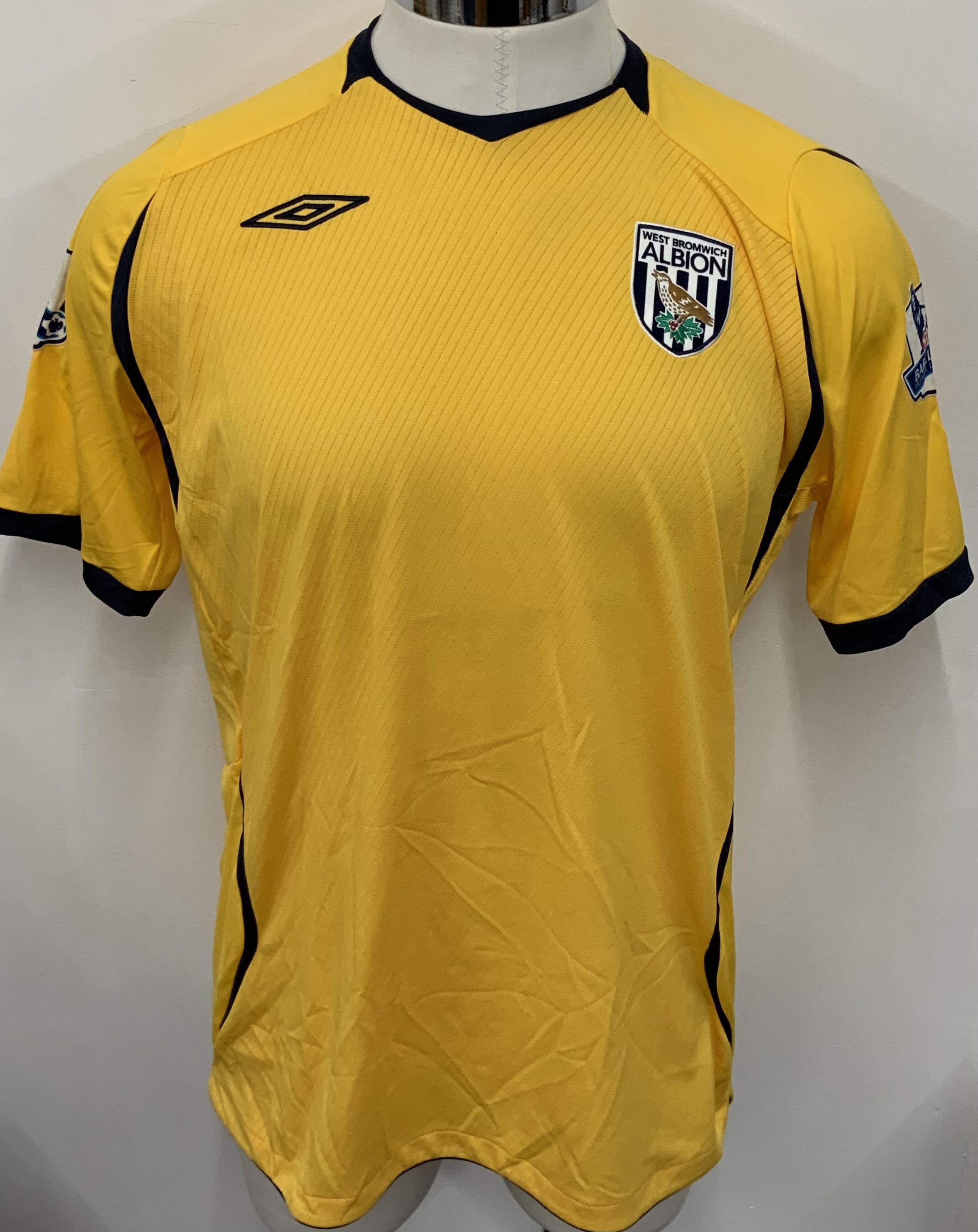 West Brom 2008 - 2009 Match Worn Football Shirt: Yellow short sleeve shirt with number 24 Martis to rear. Premier League badging to sleeves. Signed to number by the player. 