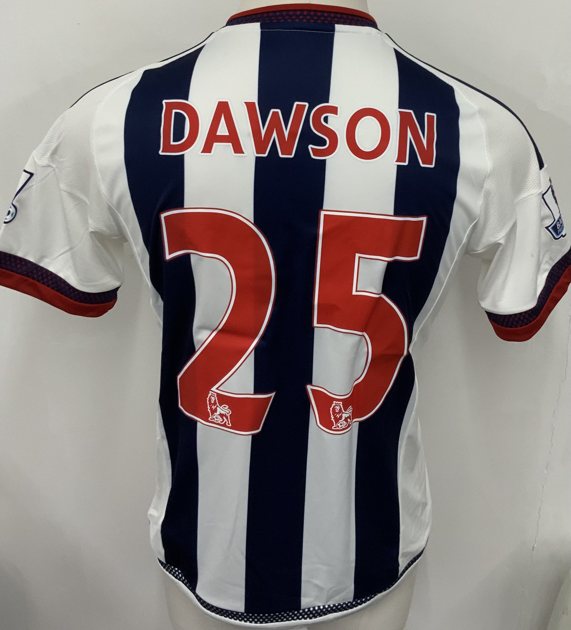 West Brom 2015 - 2016 Match Worn Football Shirt: Blue and white short sleeve shirt with Premier League badging to sleeves. Dawson 25 to rear. Worn during the 2-1 win v Arsenal on 21 November 2015, courtesy of a winning own goal from Mikel Arteta. 