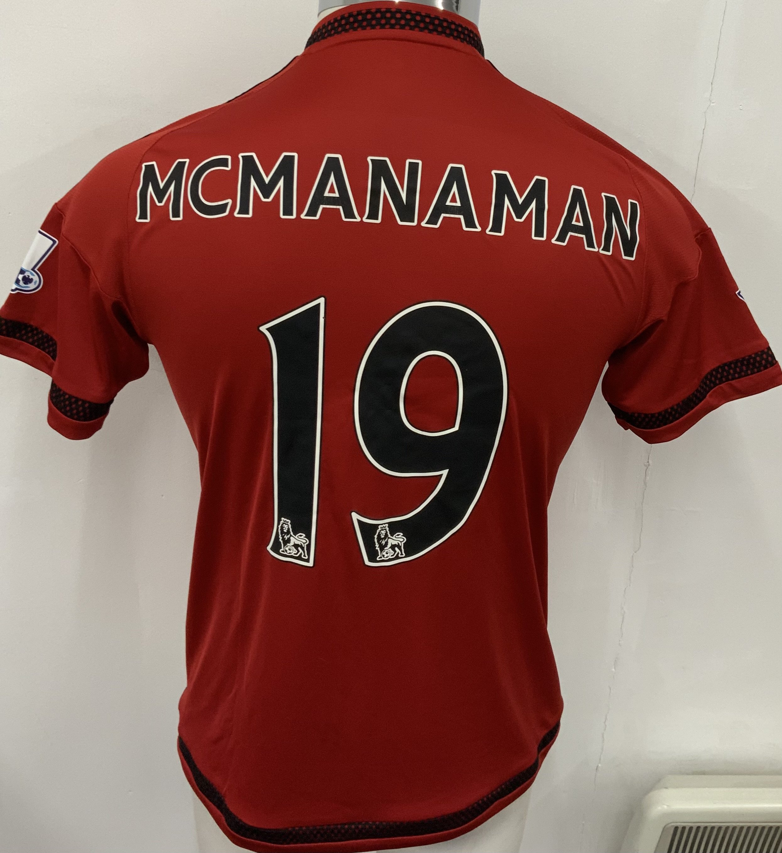 West Brom 2015 - 2016 Match Worn Football Shirt: Red and black pin striped short sleeve shirt with Premier League badging to sleeves. McManaman 19 to rear. 